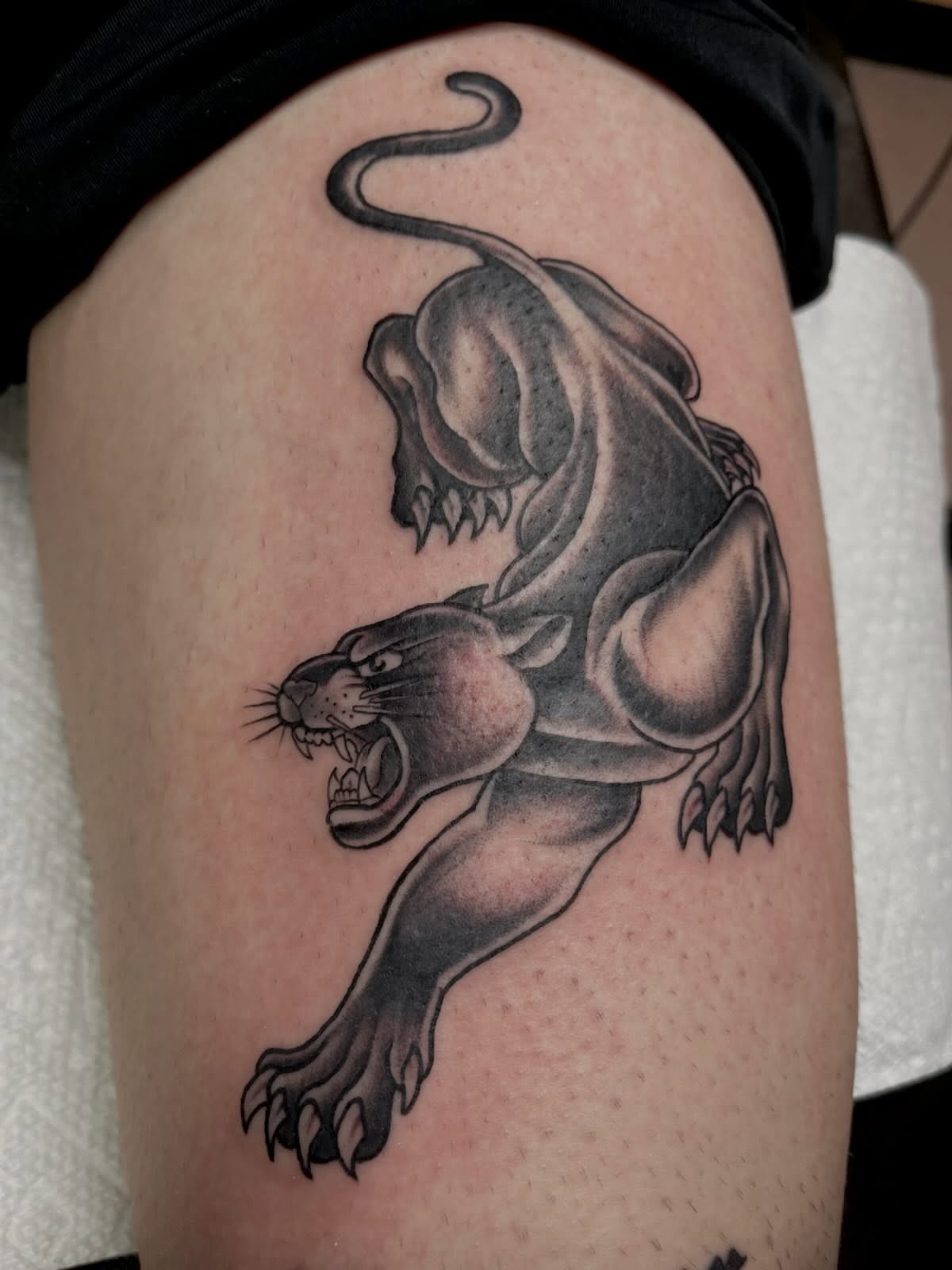 Panther black and grey tattoo on the thigh by Allison Gallagher