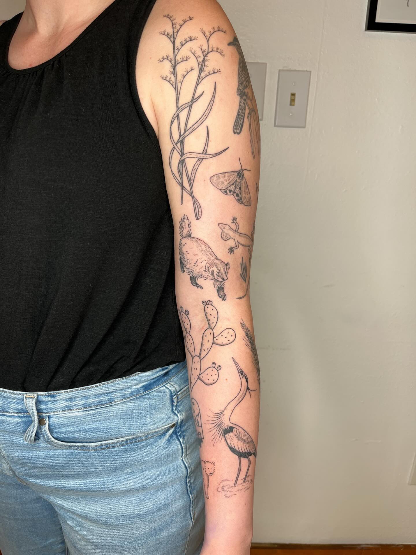 Botanical and wildlife black and grey tattoo on the forearm by natalie