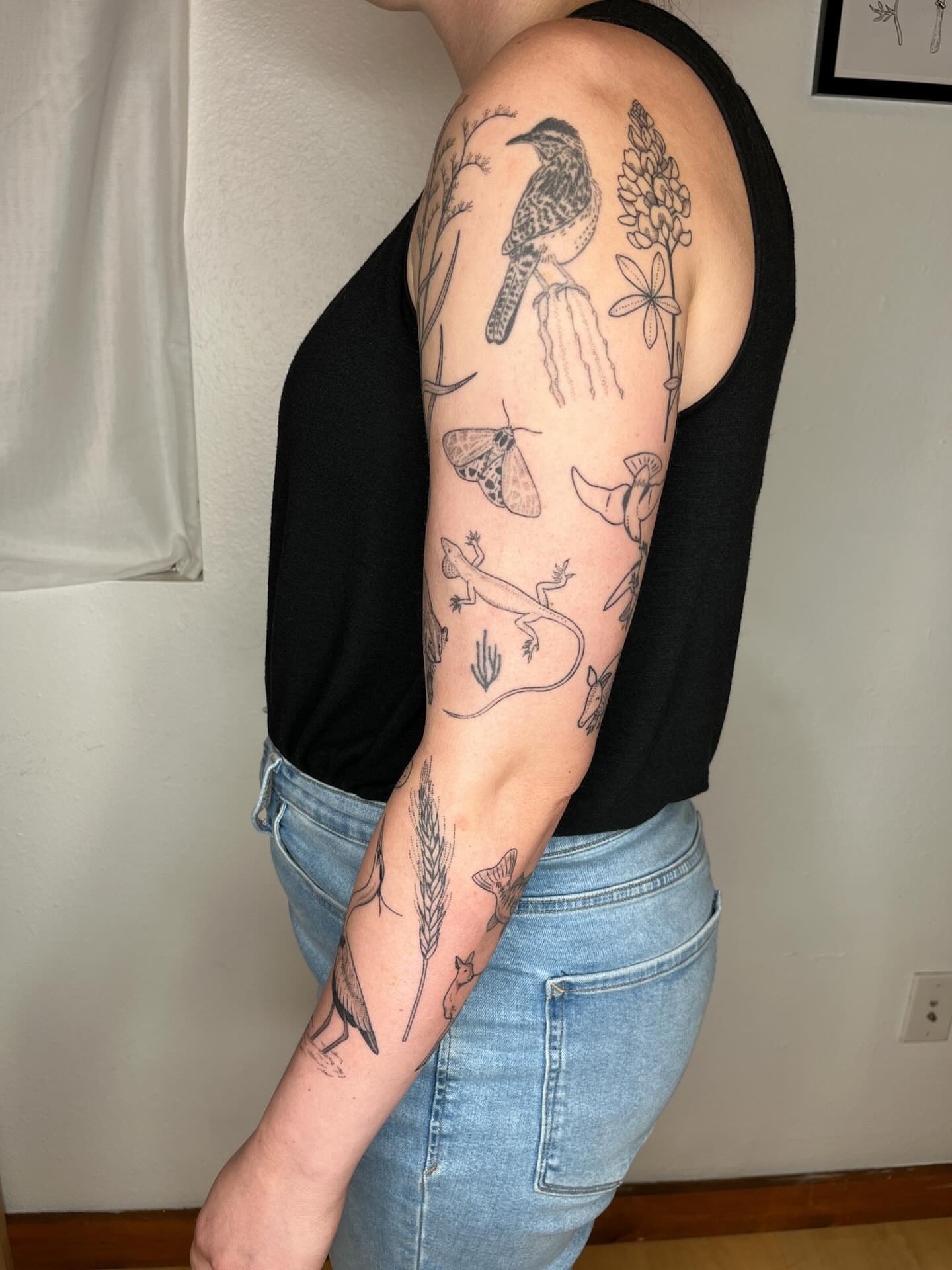 Bird and flora black and grey tattoo on the forearm by natalie