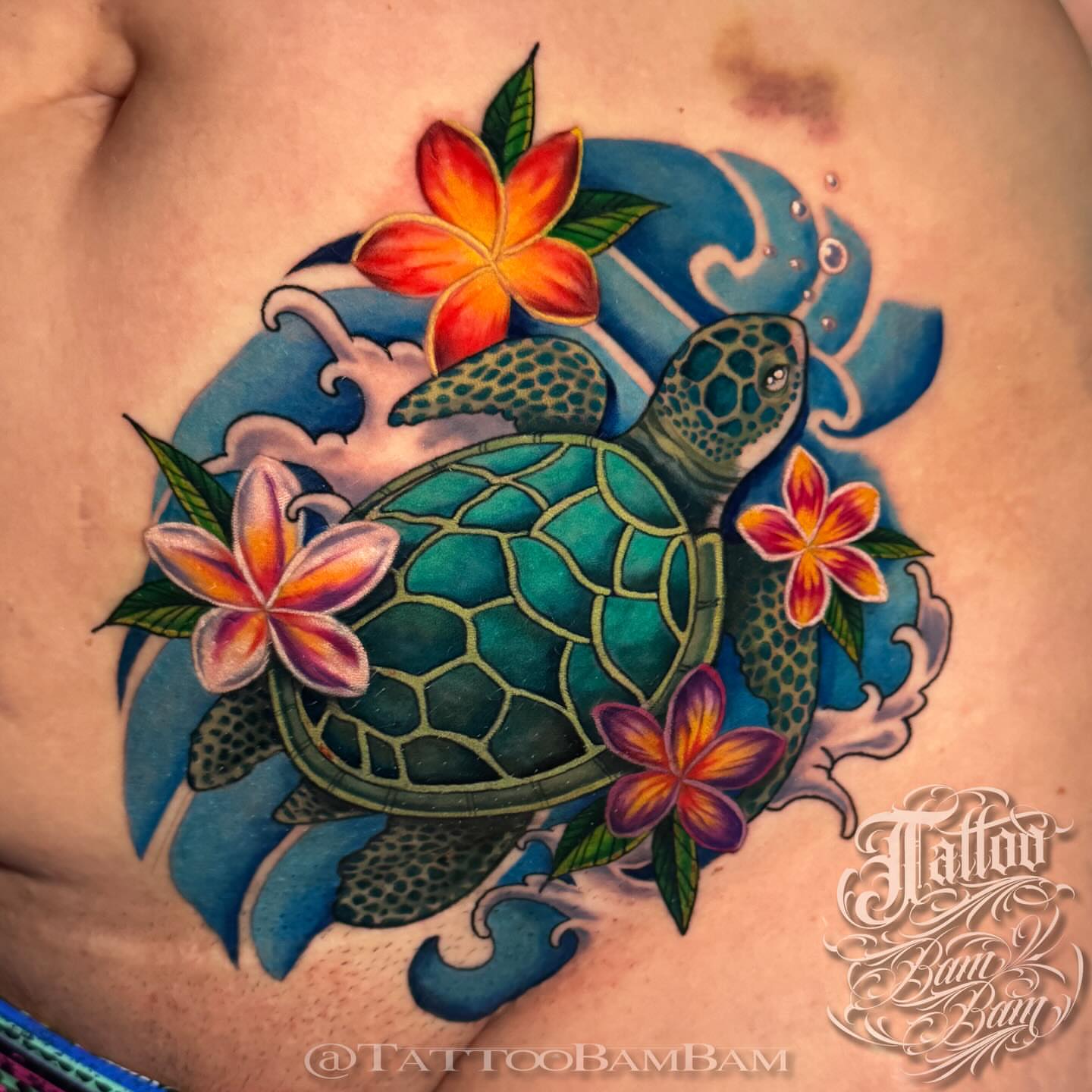 Sea turtle with flowers American traditional tattoo on the chest by Tattoo Bam Bam