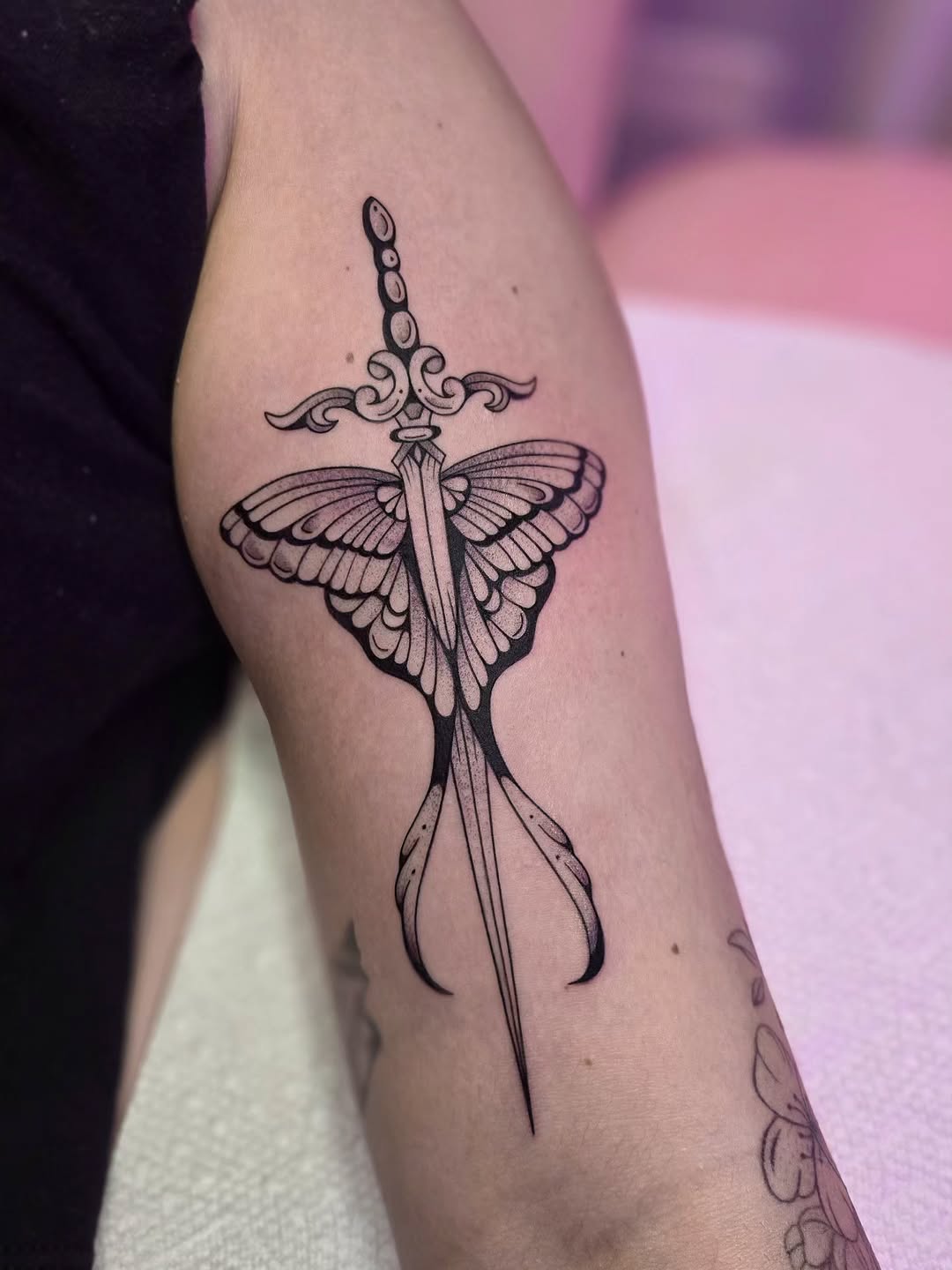 Sword and moth fine line tattoo on the forearm by Kirstie Lew Tattoo