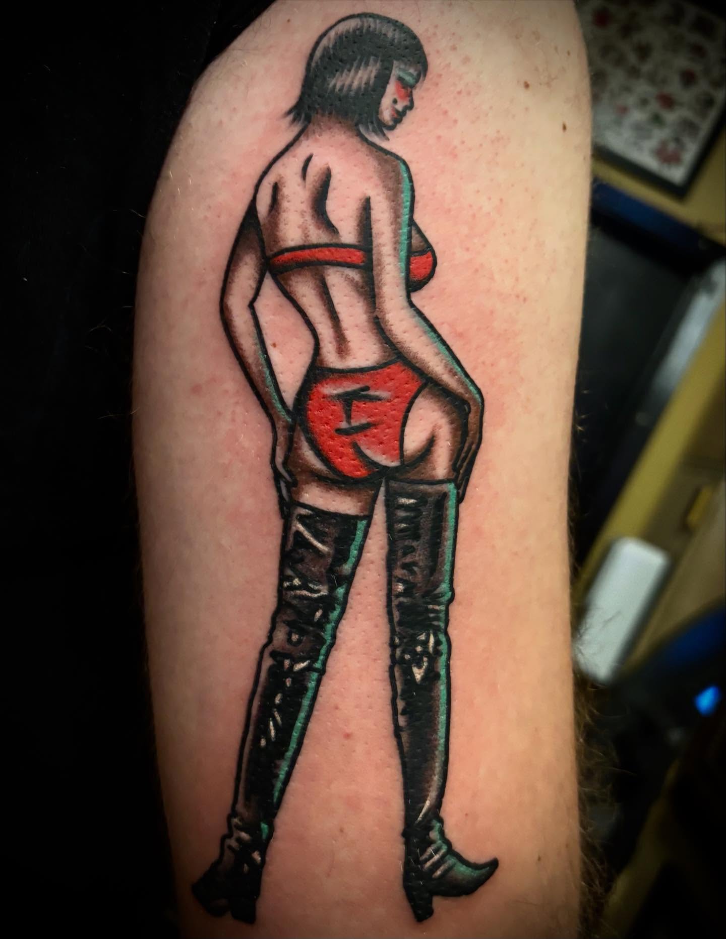 Woman in lingerie American traditional tattoo on the upper arm by Danny DiBlasi, San Francisco, California