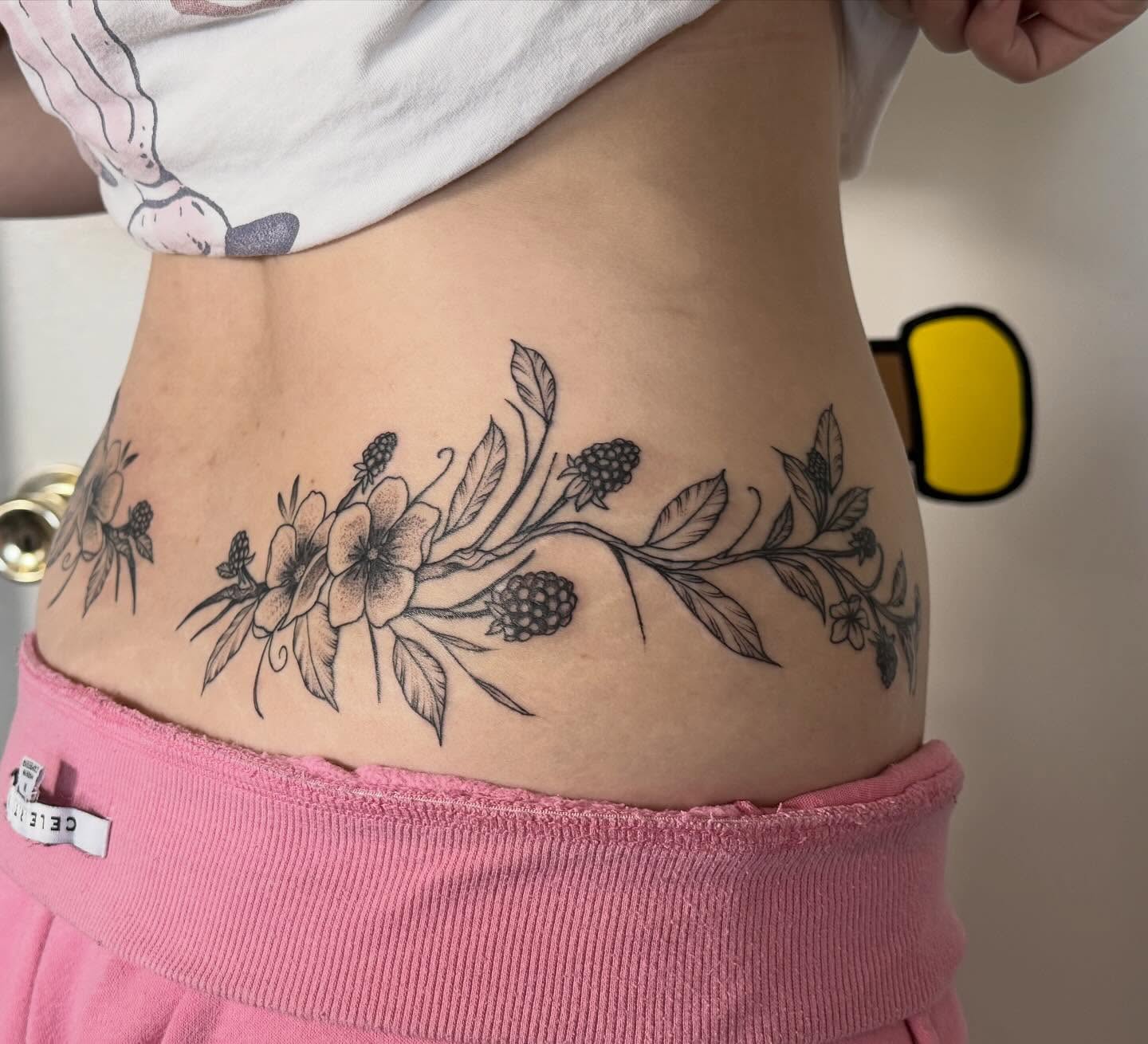 Floral arrangement black and grey tattoo on the torso by Sophia, New Carlisle, Ohio