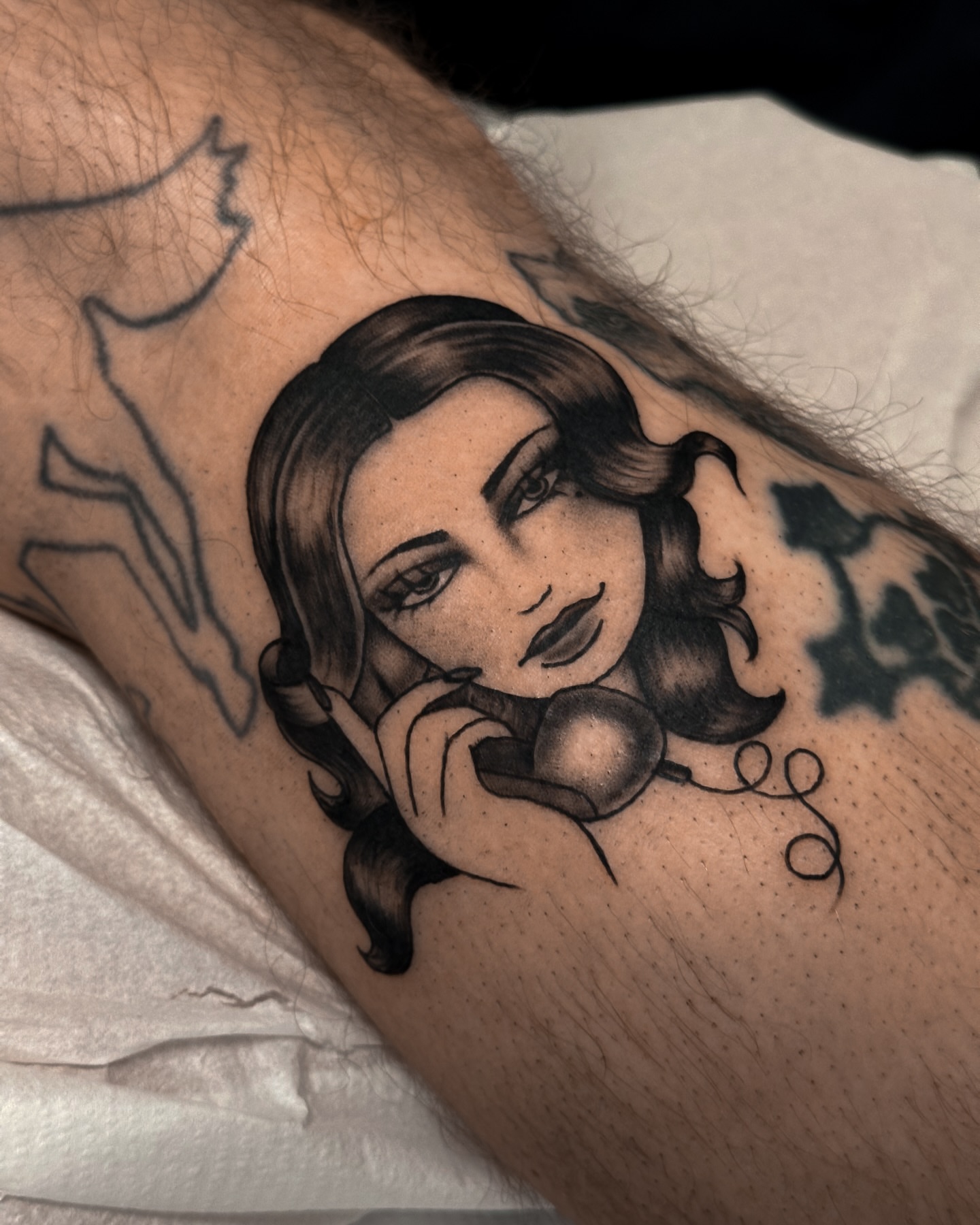 Woman with headphones black and grey tattoo on the forearm by Victoria