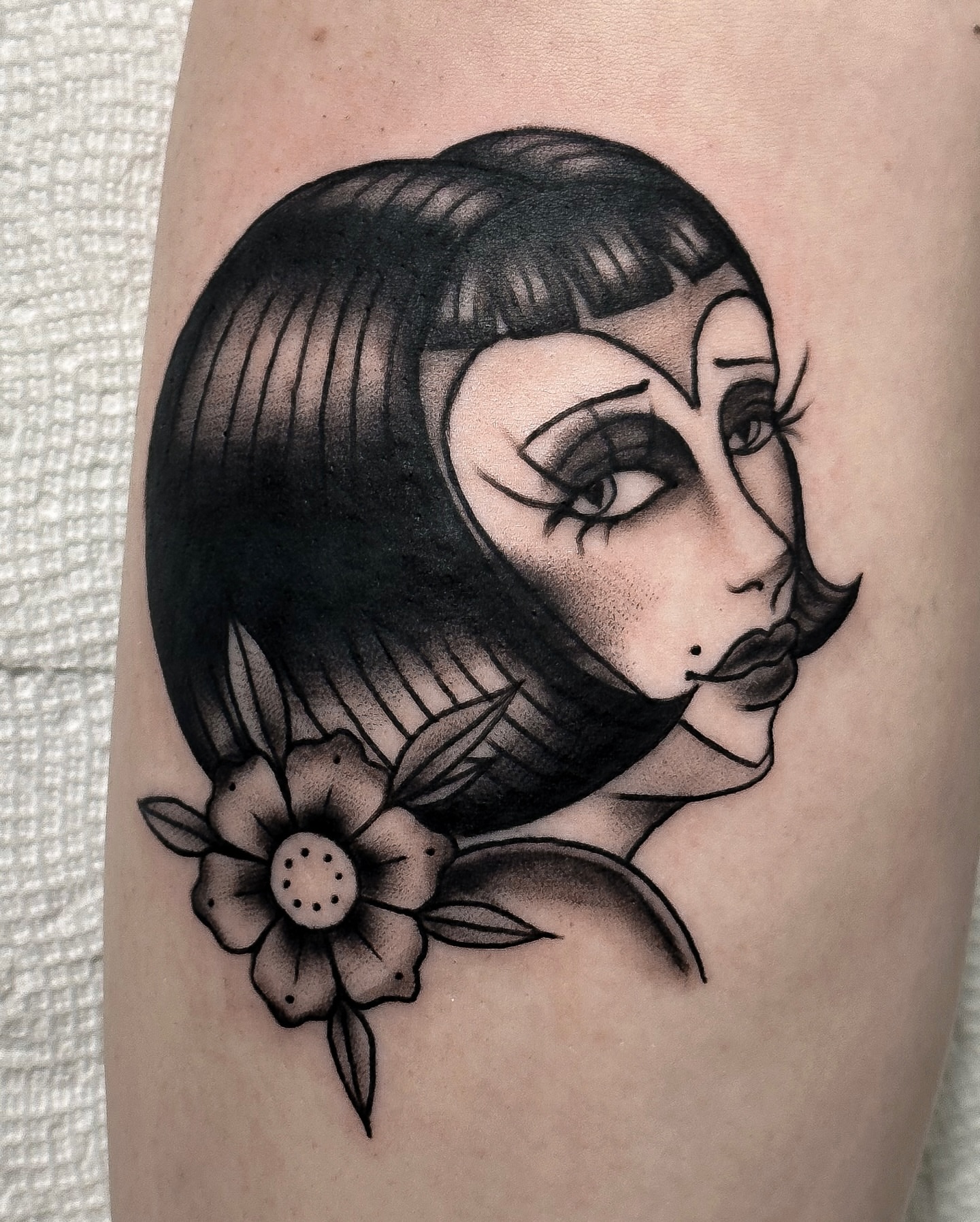 Woman with flower black and grey tattoo on the forearm by Victoria