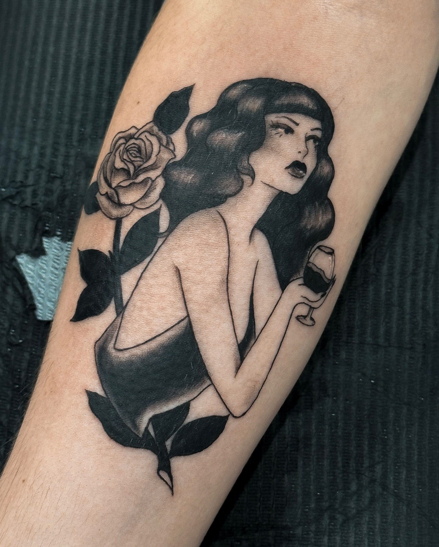 Woman with rose American traditional tattoo on the forearm by Victoria