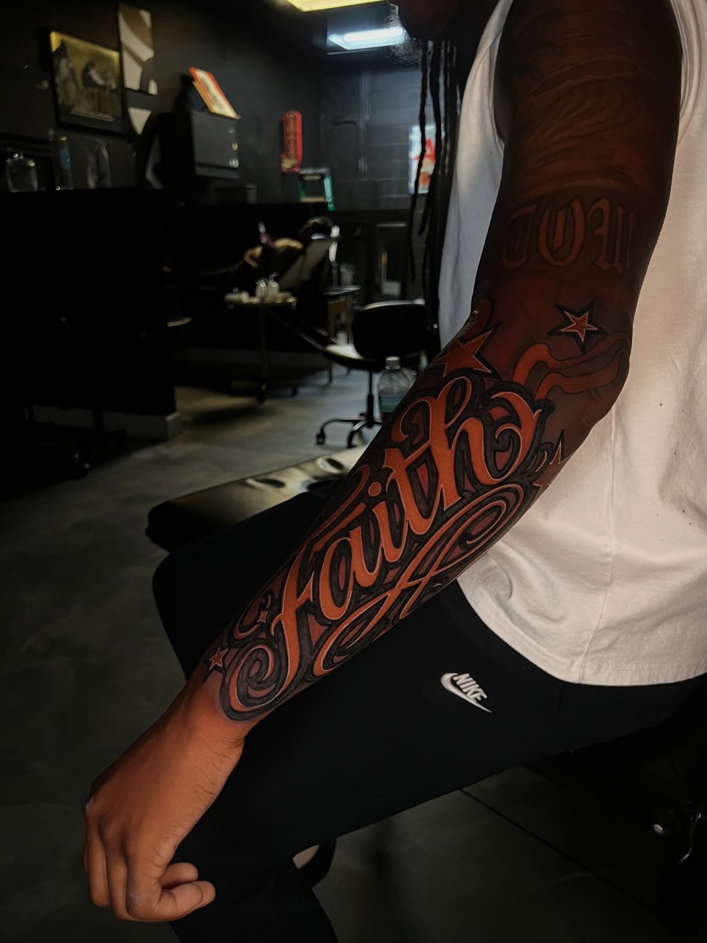 Faith lettering script tattoo on the forearm by Dee