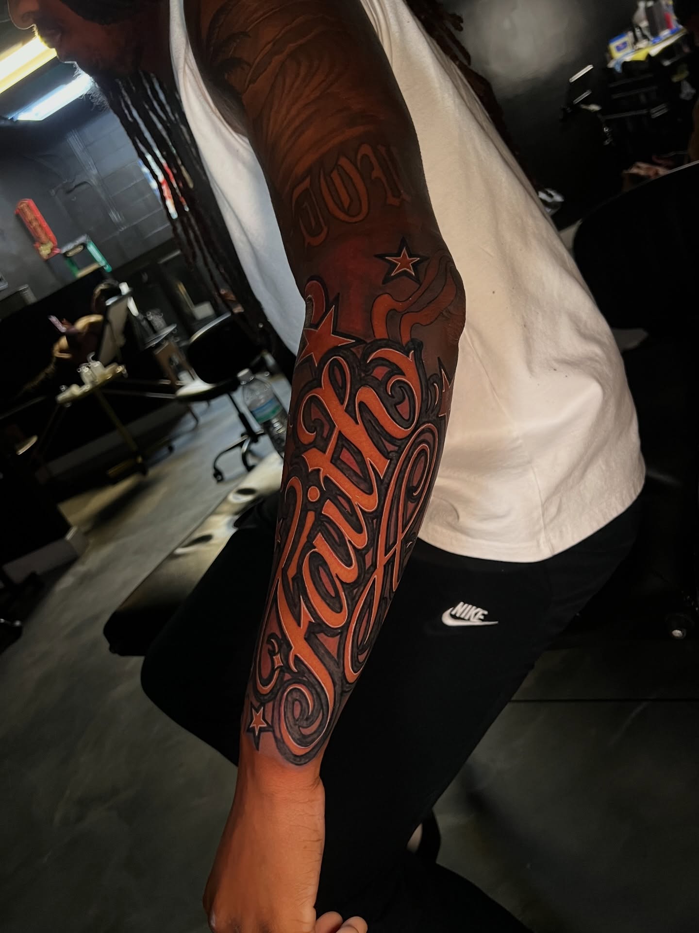 Faith lettering script tattoo on the forearm by Dee