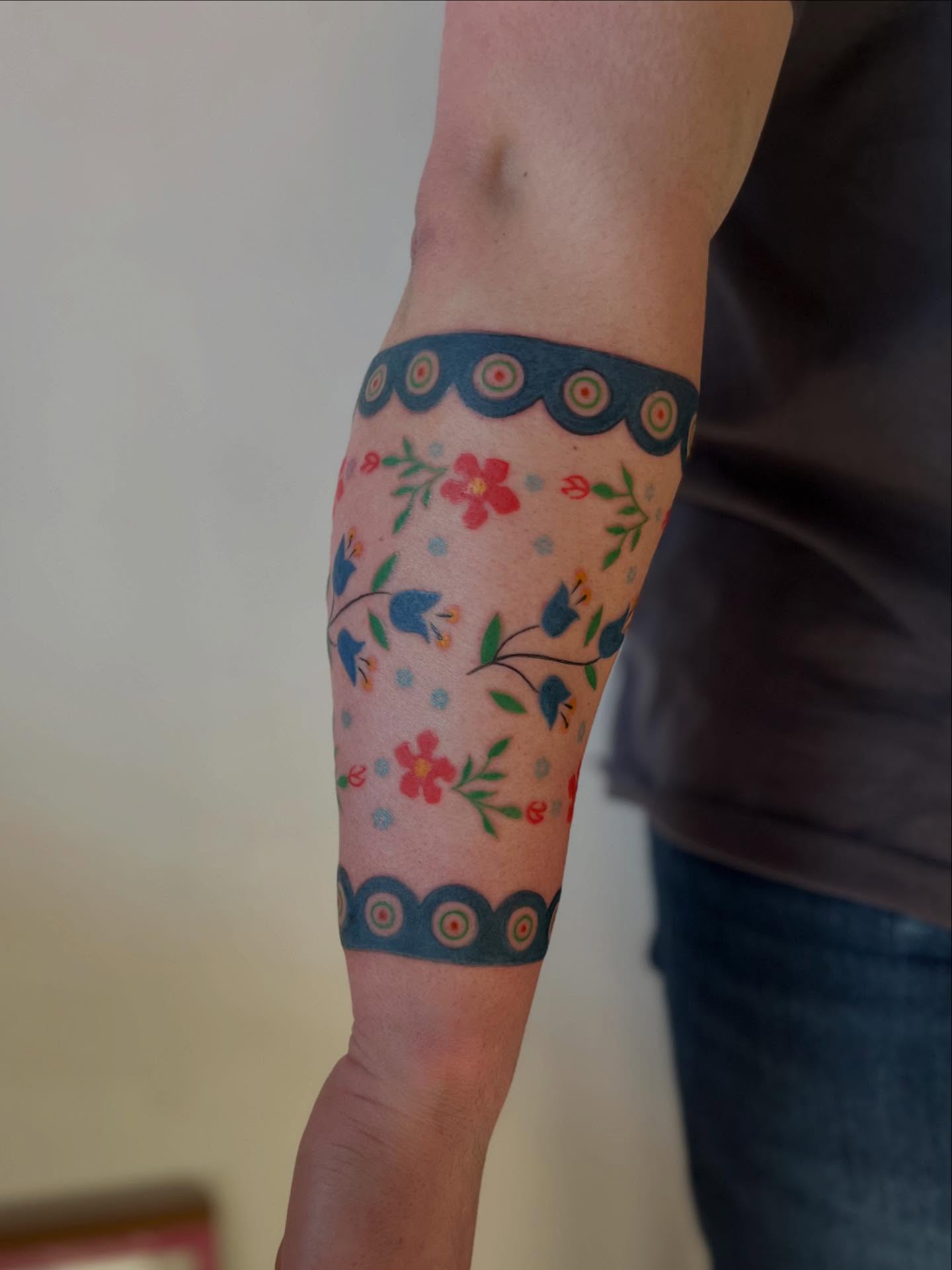 Floral pattern new school tattoo on the forearm by Maddy Anthony