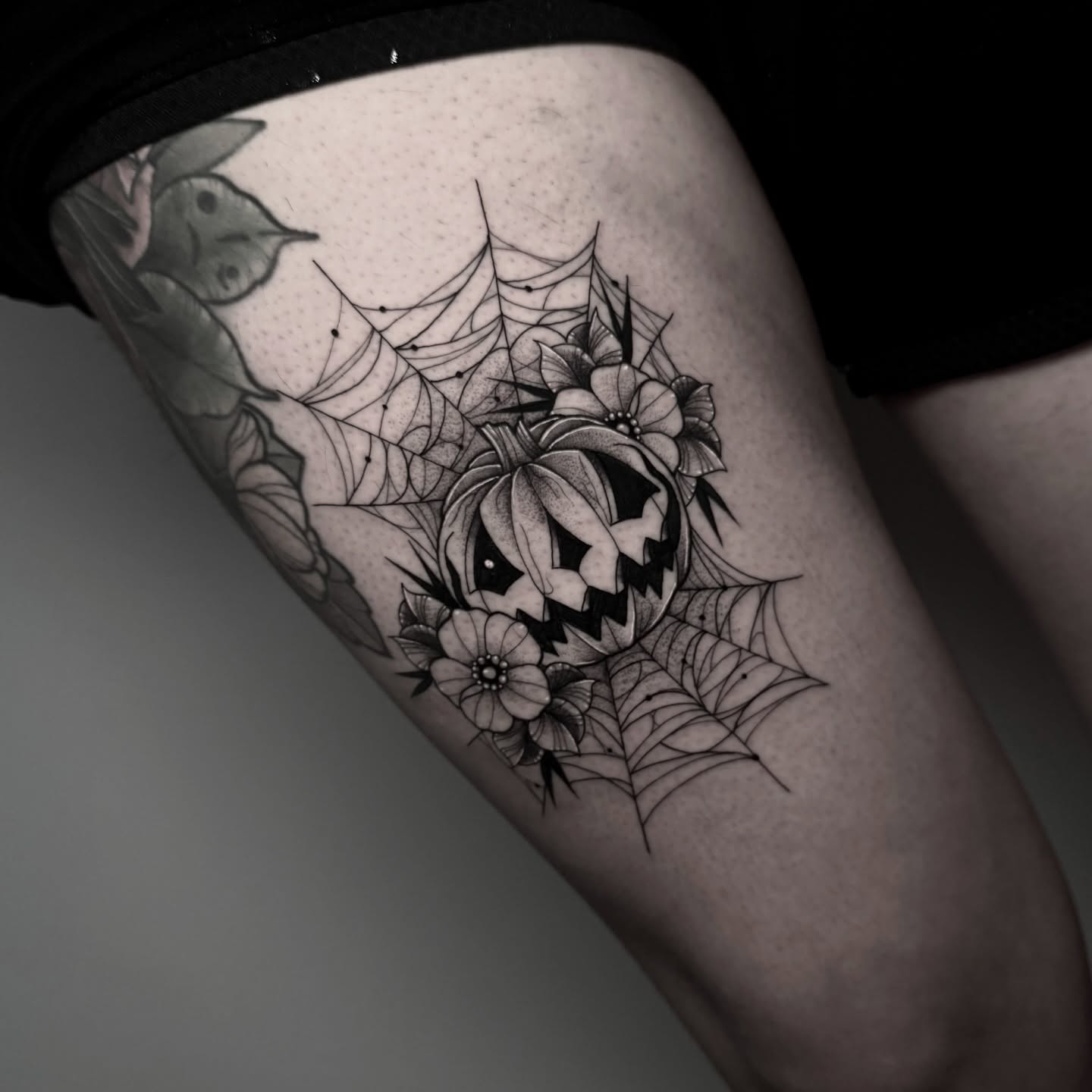 Pumpkin and spider web geometric tattoo on the thigh by ɪᴠᴏɴɴᴇ