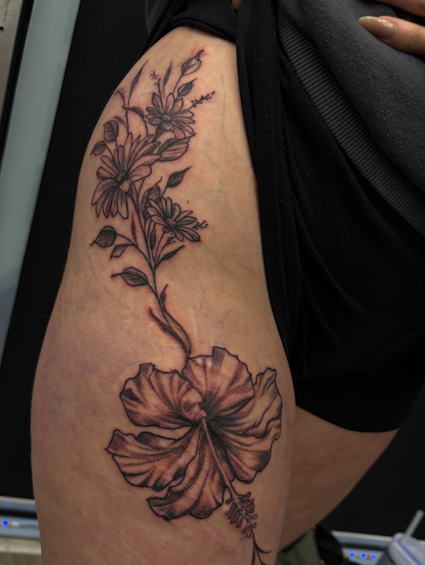 Floral arrangement black and grey tattoo on the thigh by Calen Copeland