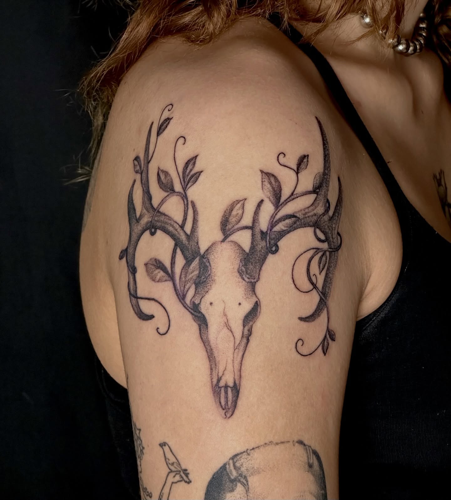 Deer skull with vines realism tattoo on the shoulder by Zoe Arrigo