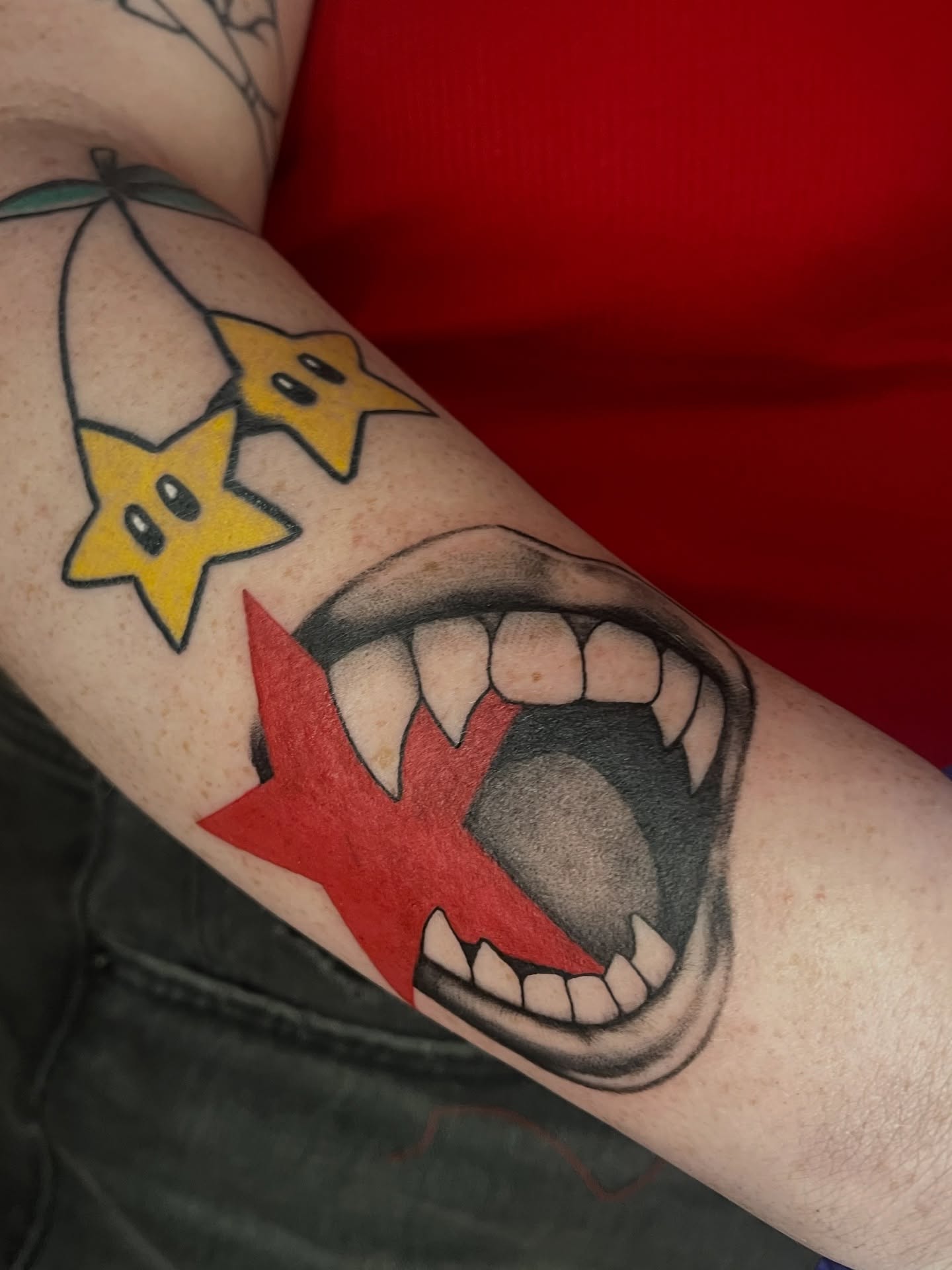 Open mouth with stars realism tattoo on the forearm by Zoe Phan, Richmond, Virginia