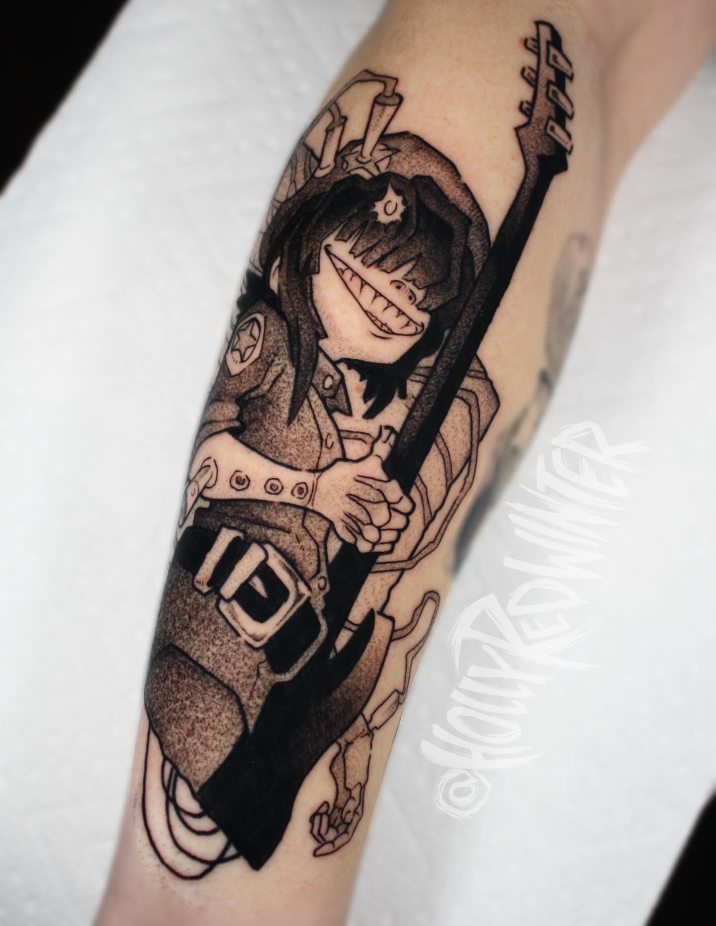 Rock star black and grey tattoo on the forearm by Holly Redwinter