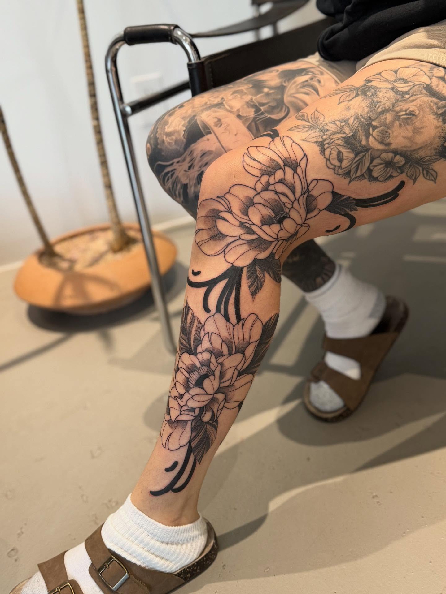 Floral black and grey tattoo on the leg by Julianna