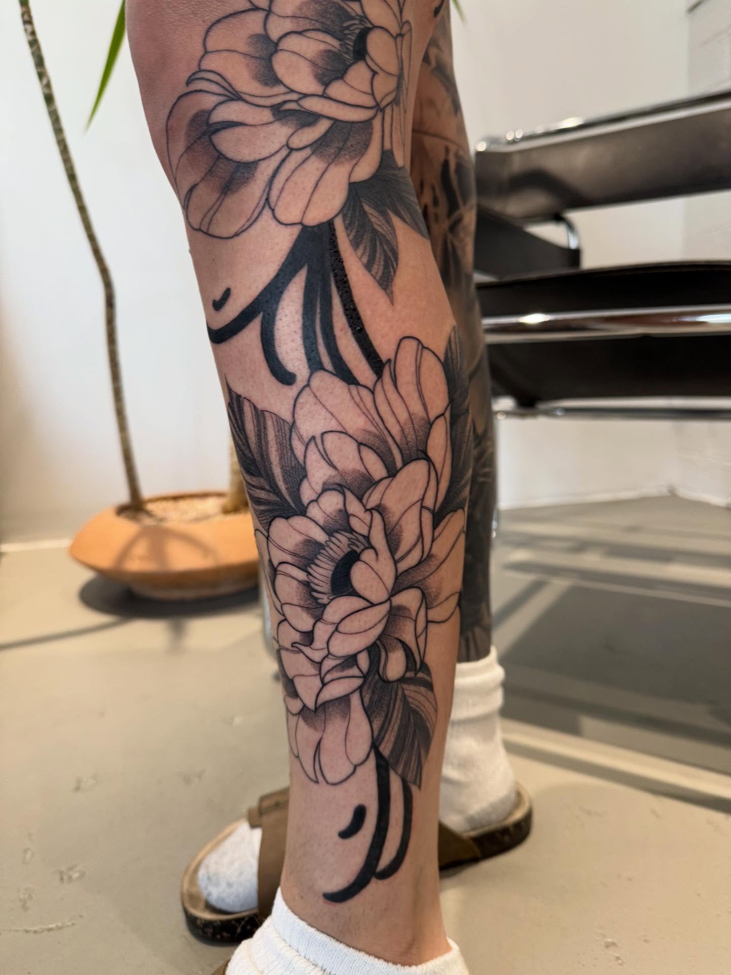 Peony flowers black and grey tattoo on the calf by Julianna