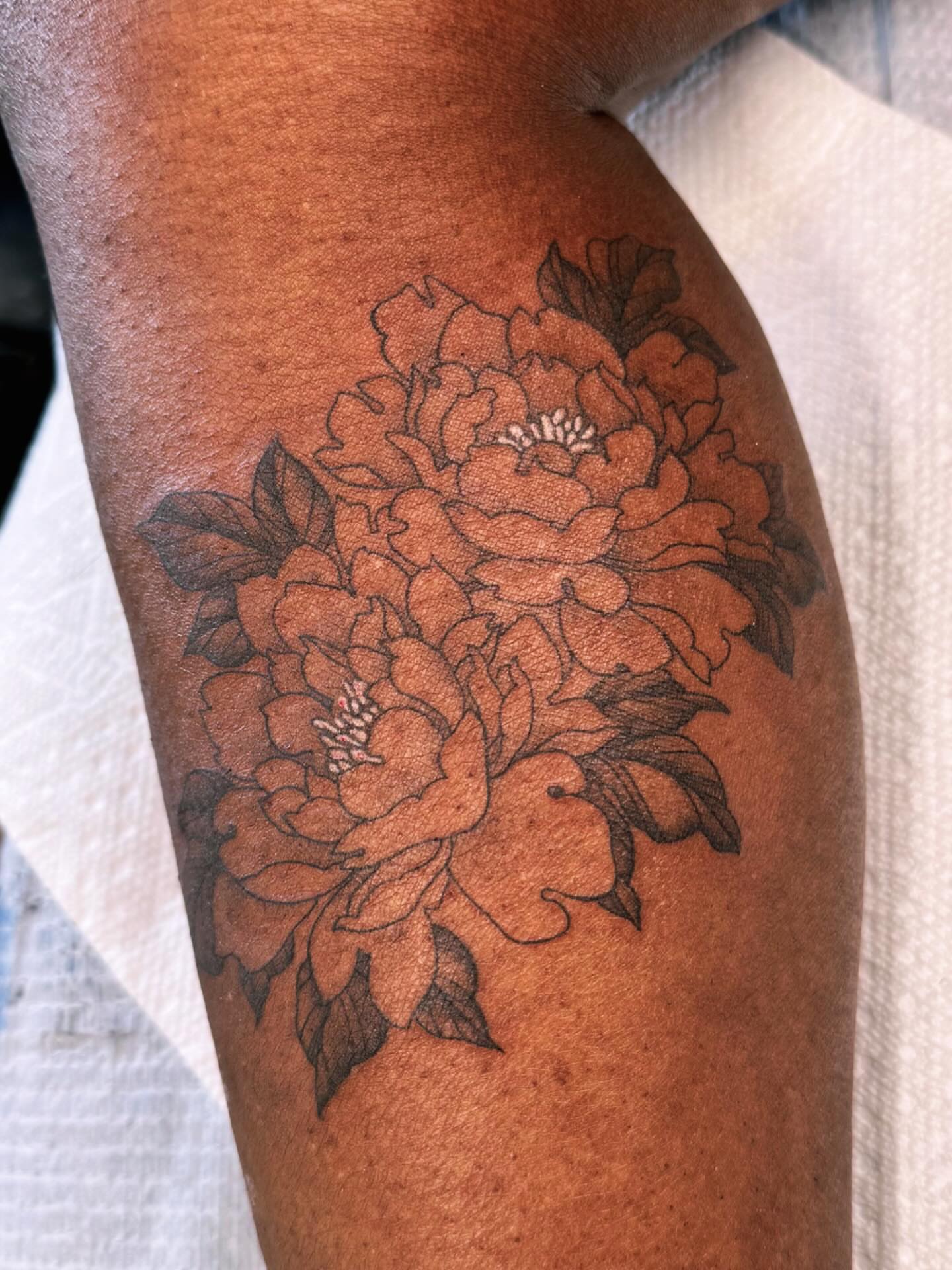 Peony black and grey tattoo on the thigh by Hillary