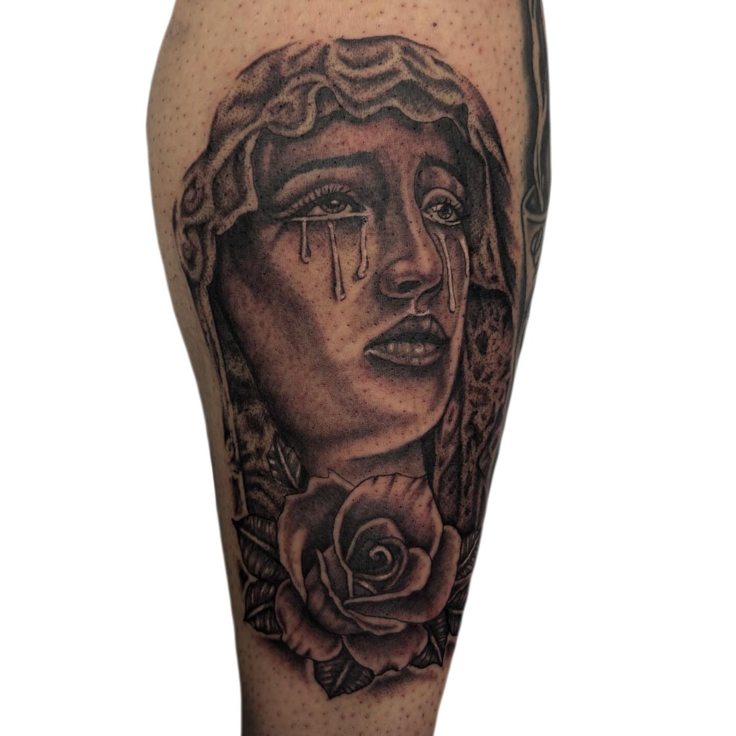 Woman crying with rose realism tattoo on the forearm by Ava Brady Tattoos