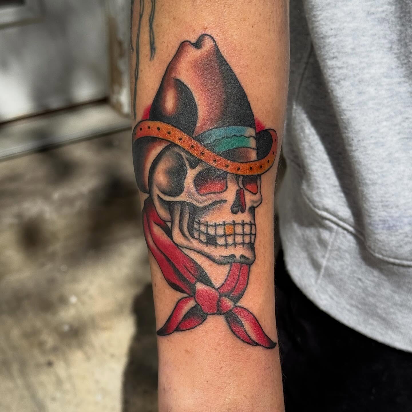 Skull with bandana American traditional tattoo on the forearm by Jack Hatchet Tattoos