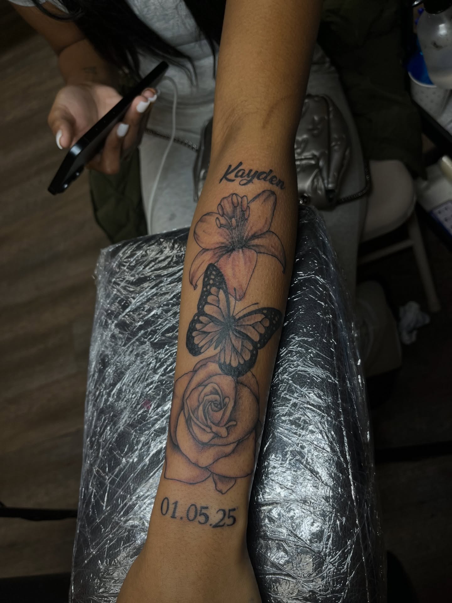 Flower, butterfly, rose, date black and grey tattoo on the forearm by Tam💟👩🏽‍🎨