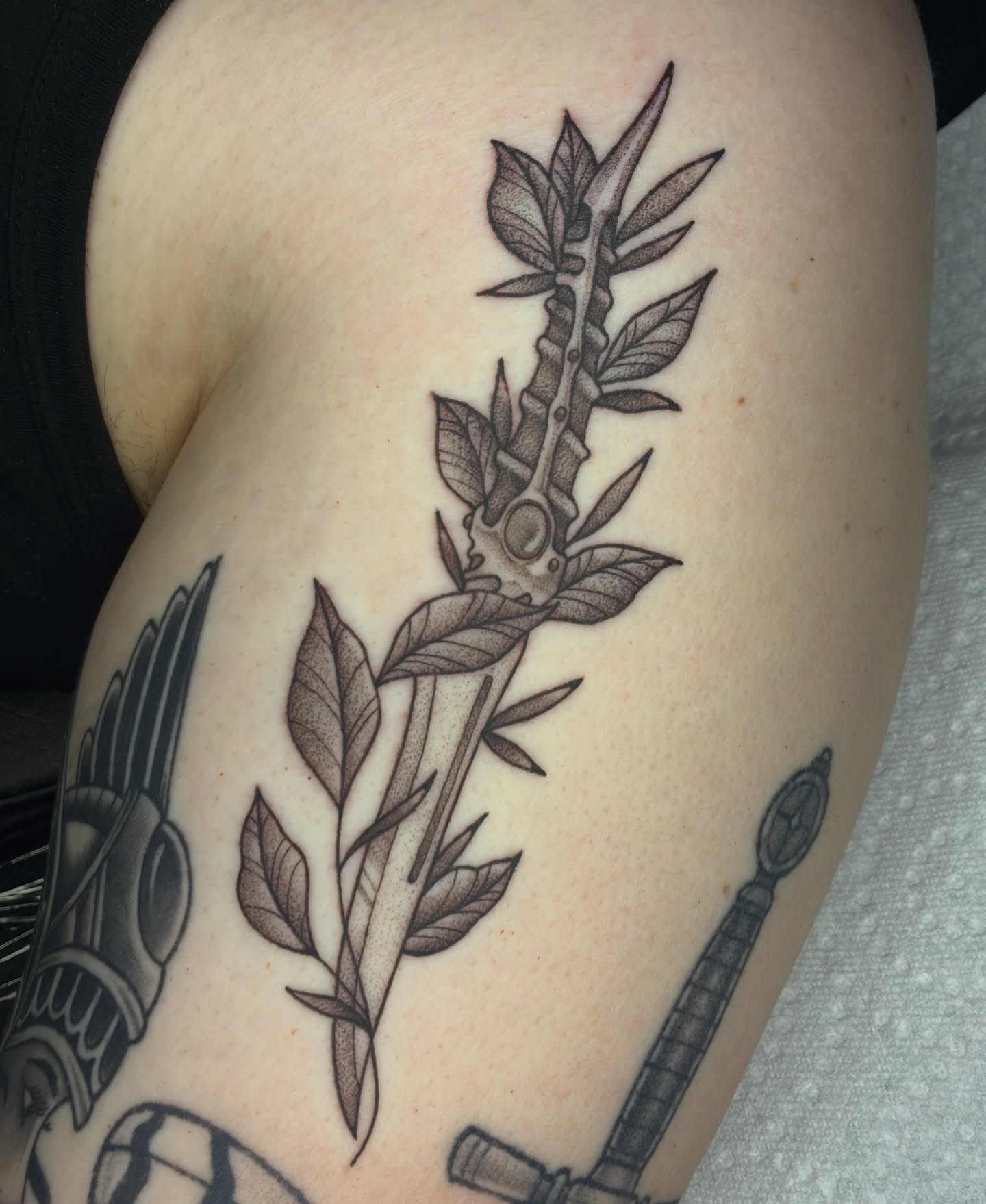 Plant with sword black and grey tattoo on the thigh by Lance 🦈