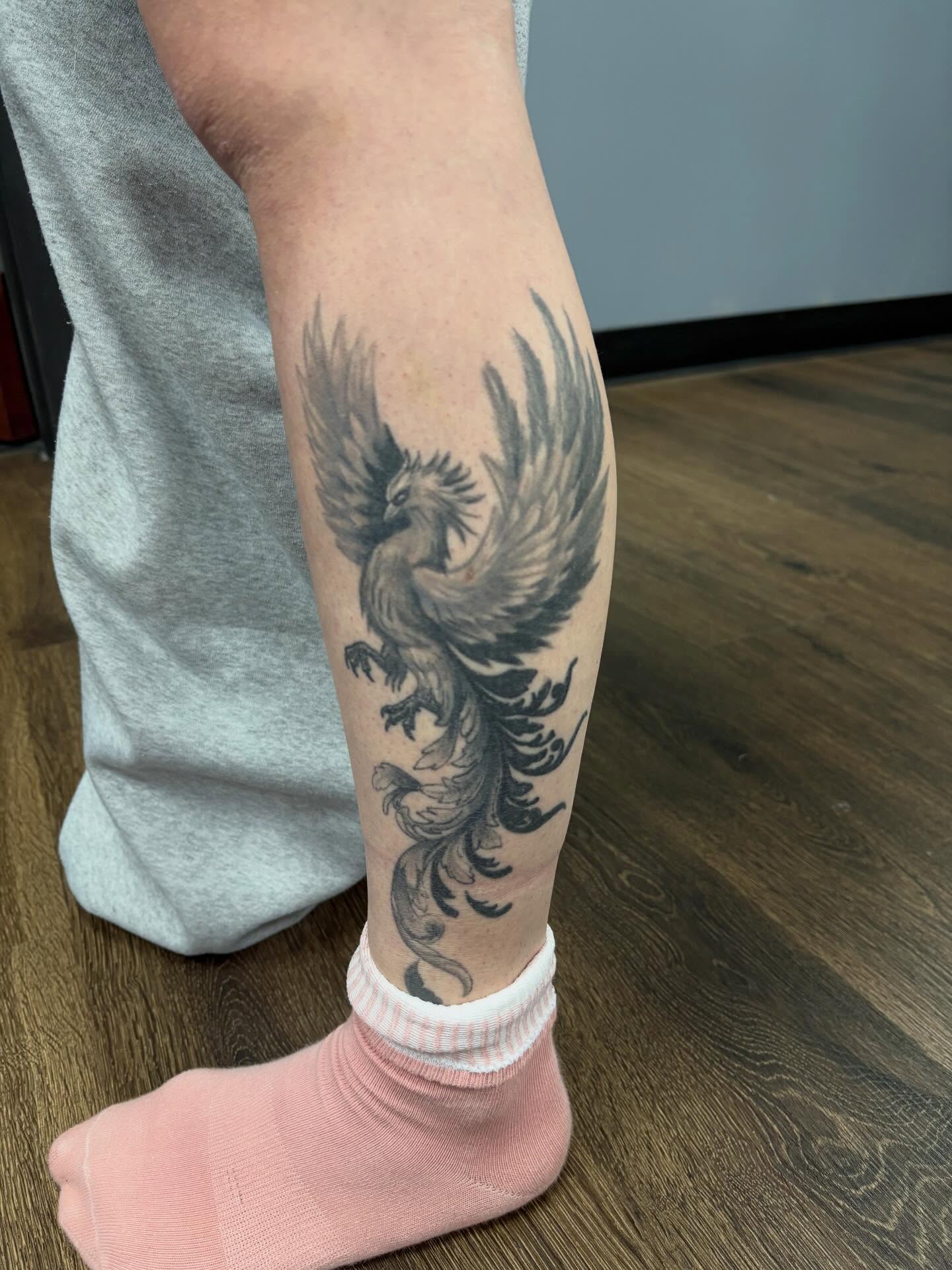 Phoenix black and grey tattoo on the calf by Jack Ferreri