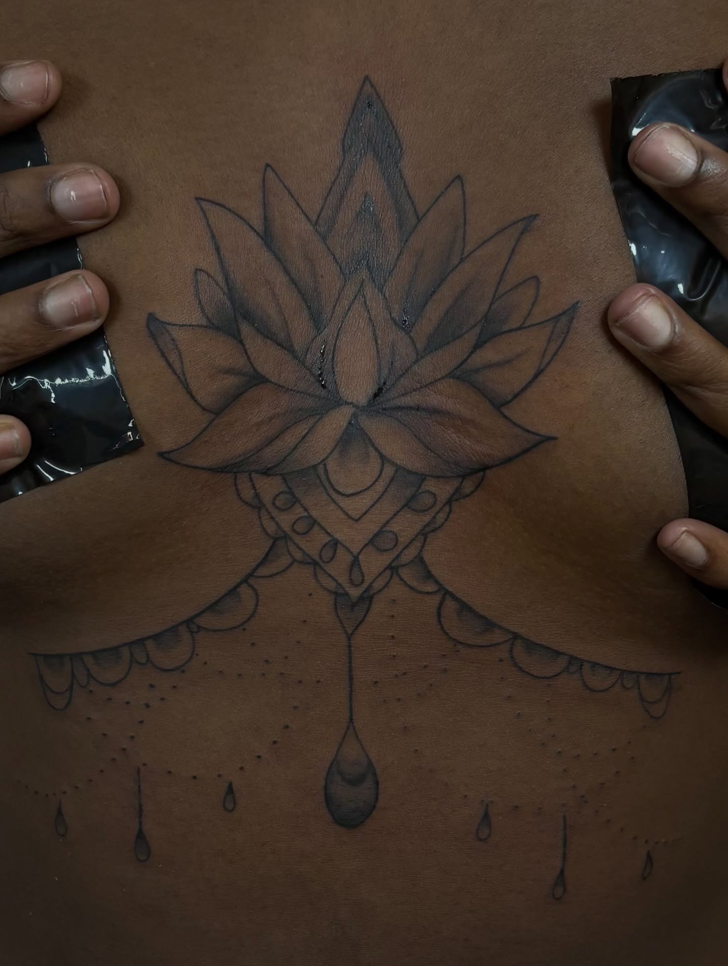 Lotus flower black and grey tattoo on the chest by Tam💟👩🏽‍🎨