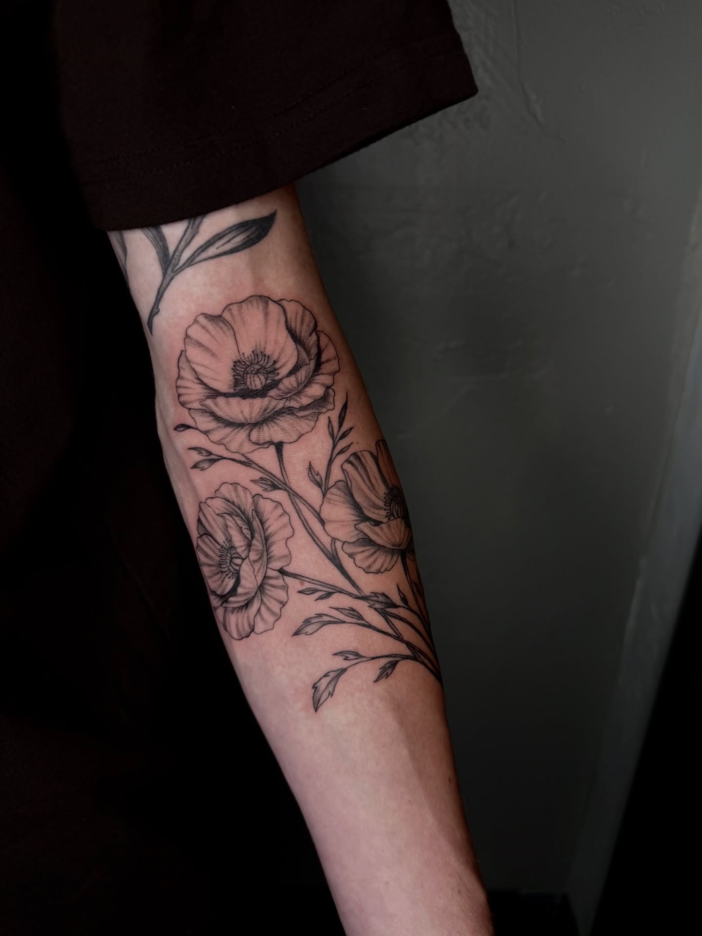 Poppy flowers black and grey tattoo on the forearm by jayla pantig