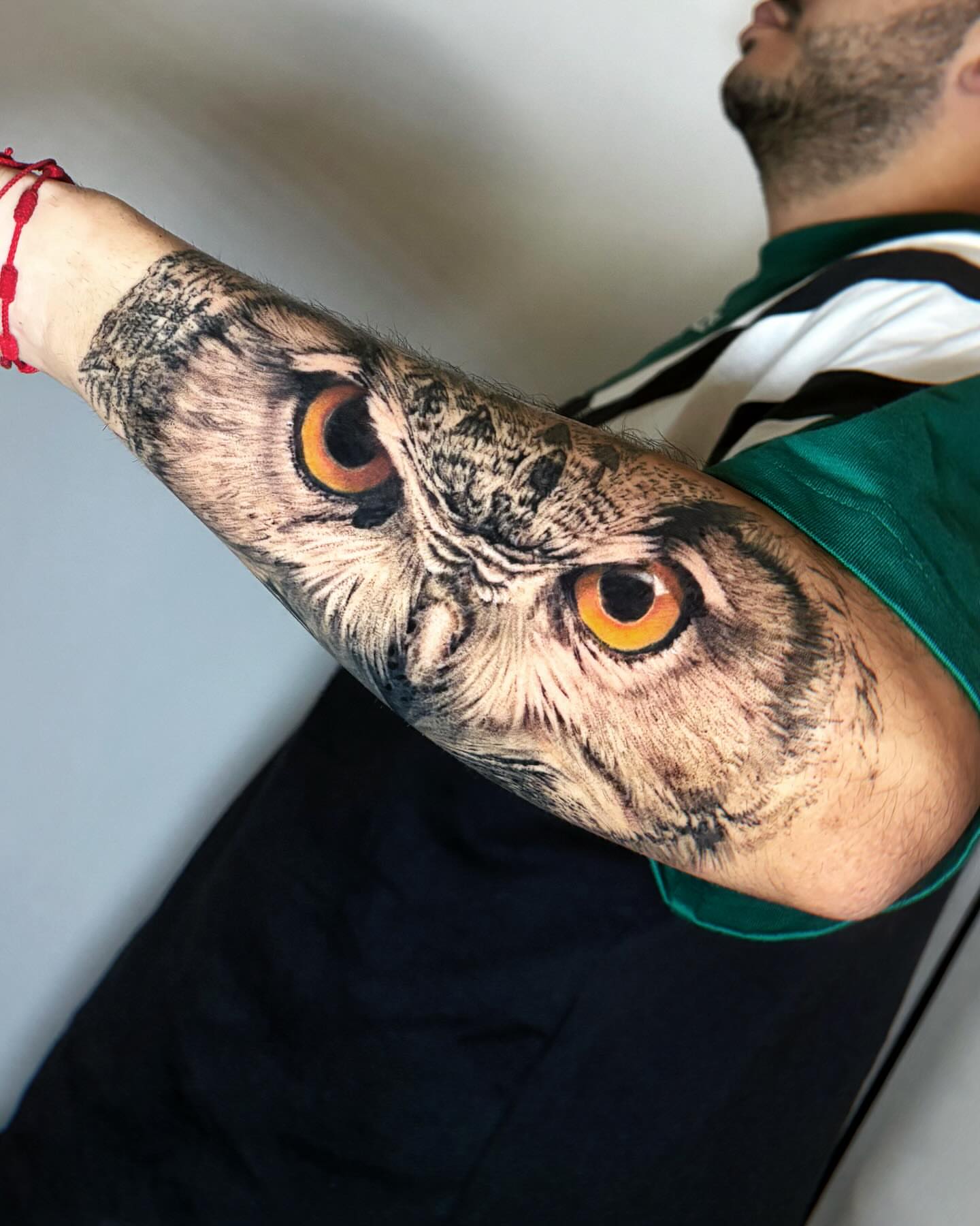 Owl realism tattoo on the upper arm by Yu Chen