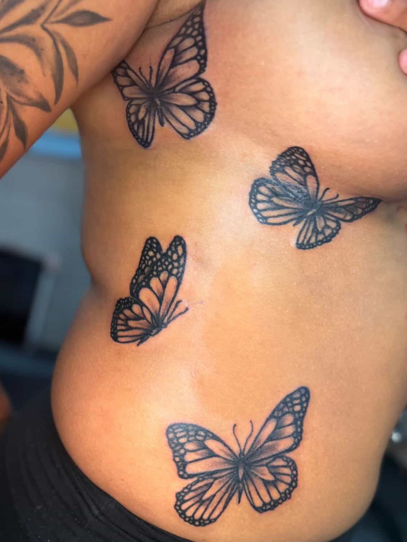 Monarch butterflies black and grey tattoo on the ribs by JAE, Shreveport, Louisiana