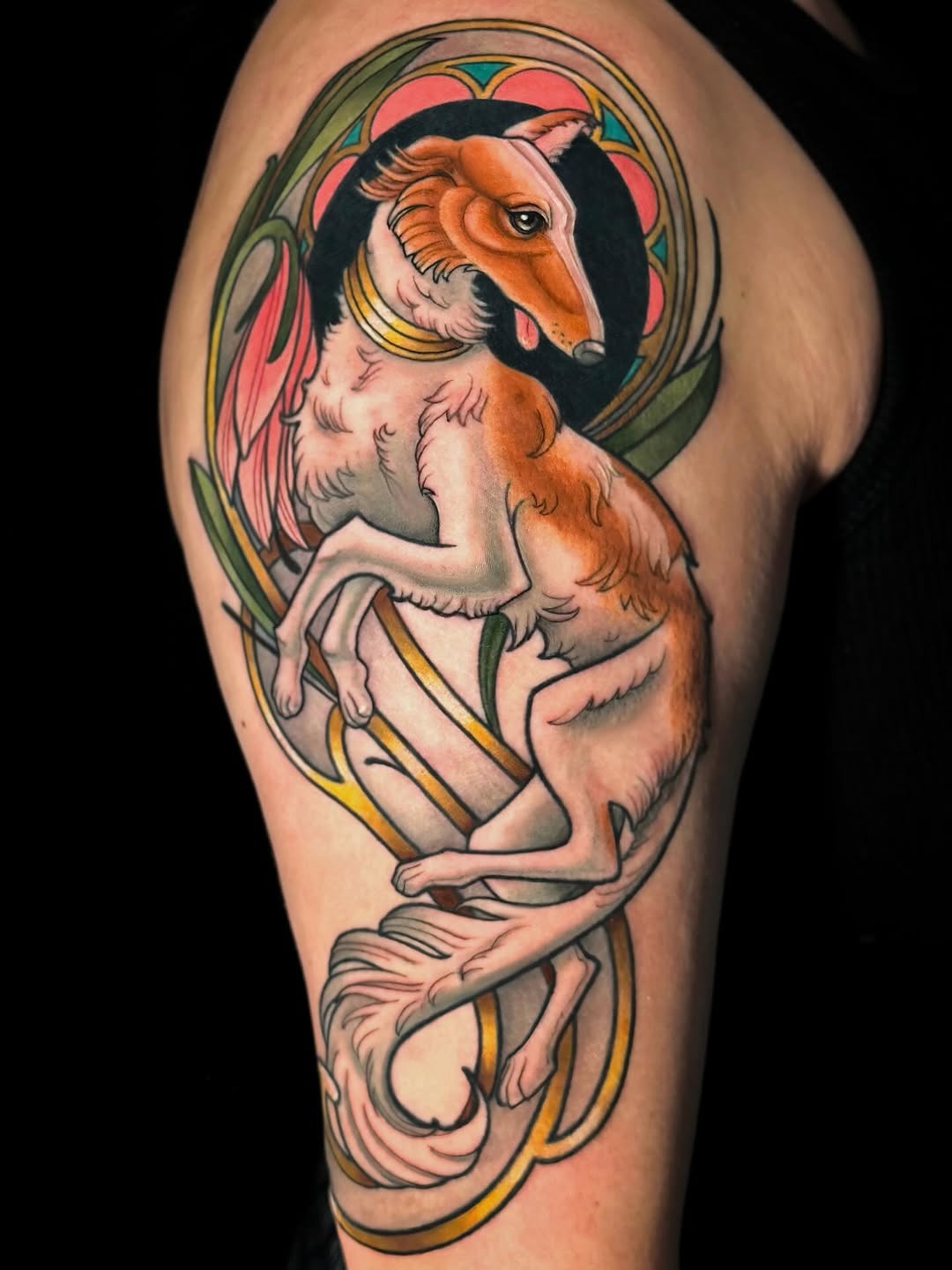 Borzoi dog with floral elements realism tattoo on the upper arm by Cortney Norton