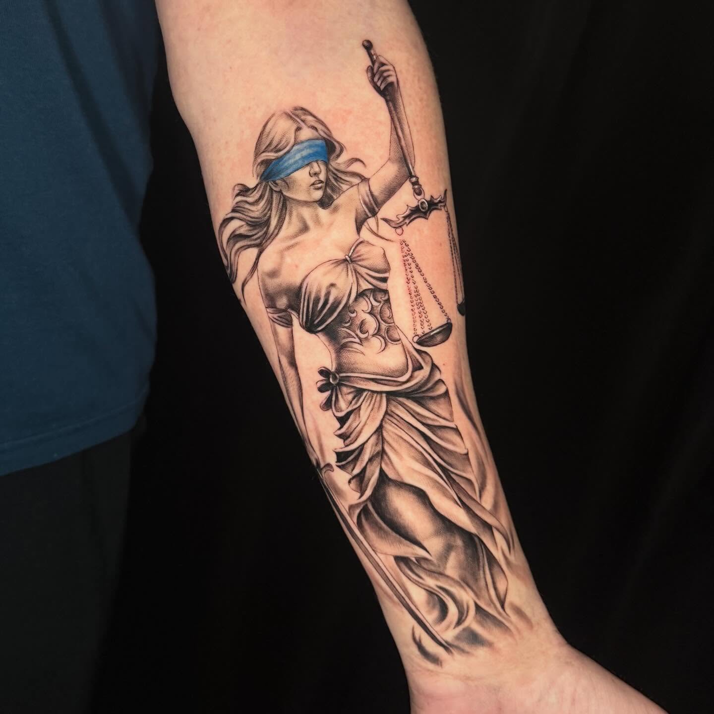 Lady Justice realism tattoo on the forearm by Angela Azure