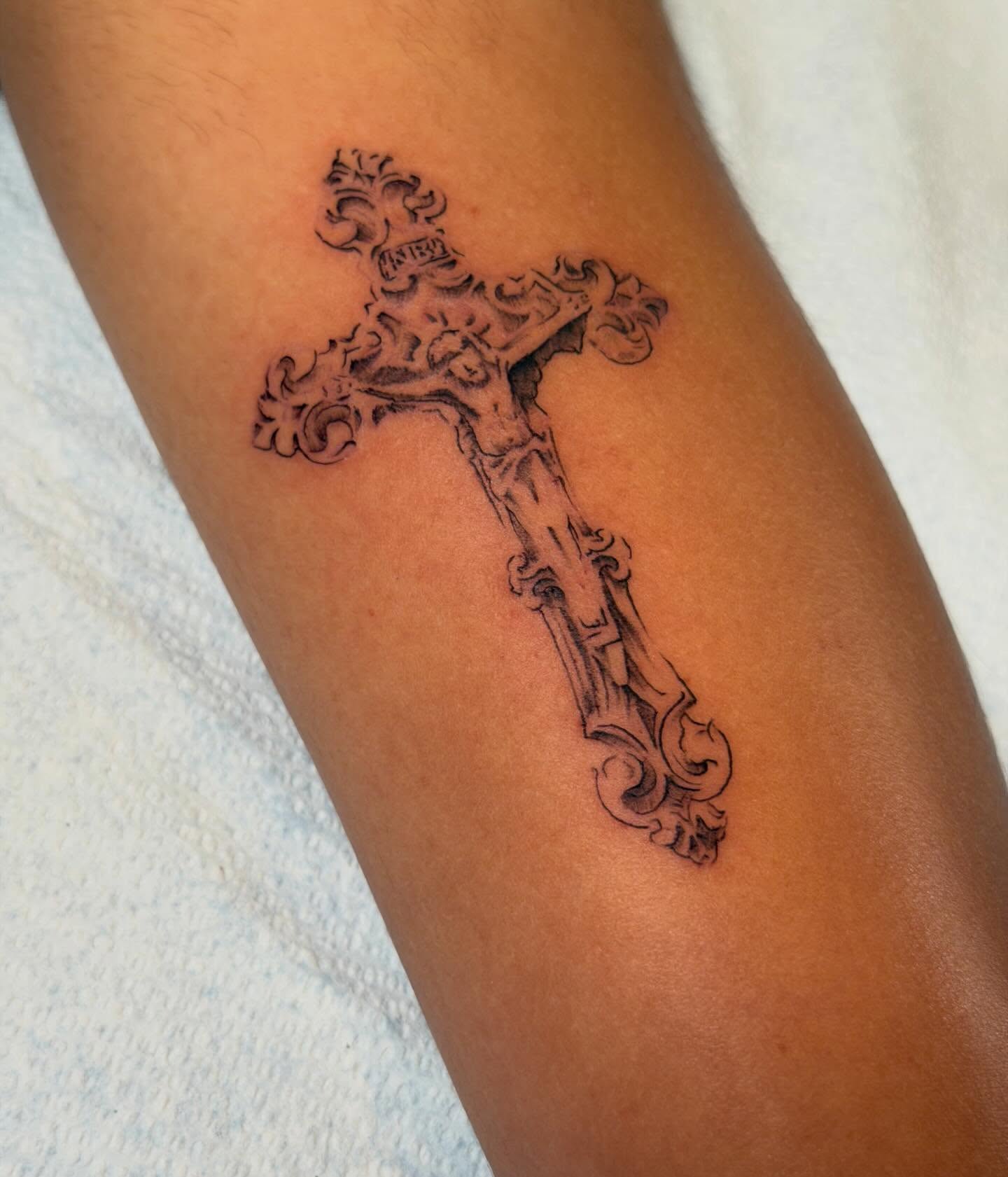 Cross black and grey tattoo on the forearm by James Nelson