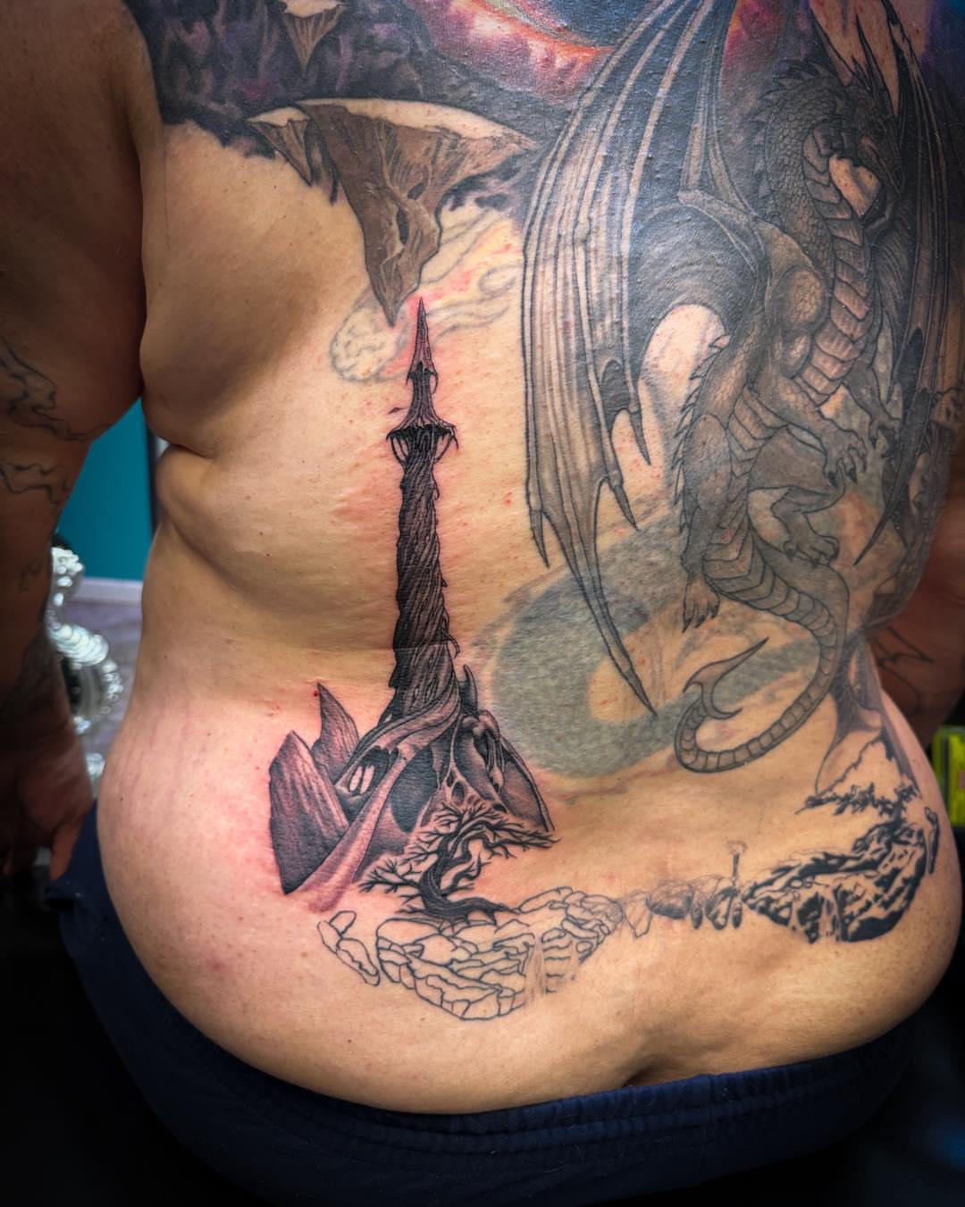 Dragon and tower realism tattoo on the back by 𝔻𝕖𝕣𝕣𝕚𝕔𝕜 𝔹𝕦𝕪𝕖𝕒, East Aurora, New York