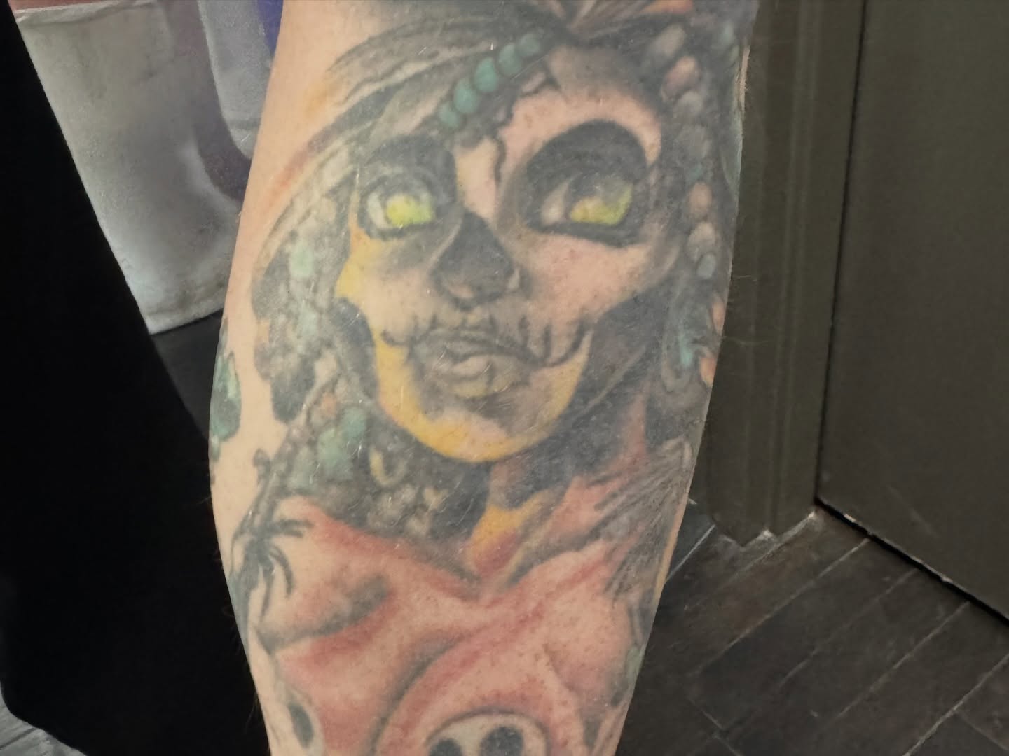Skeleton with green eyes realism tattoo on the forearm by Joe Capobianco, New Haven, Connecticut