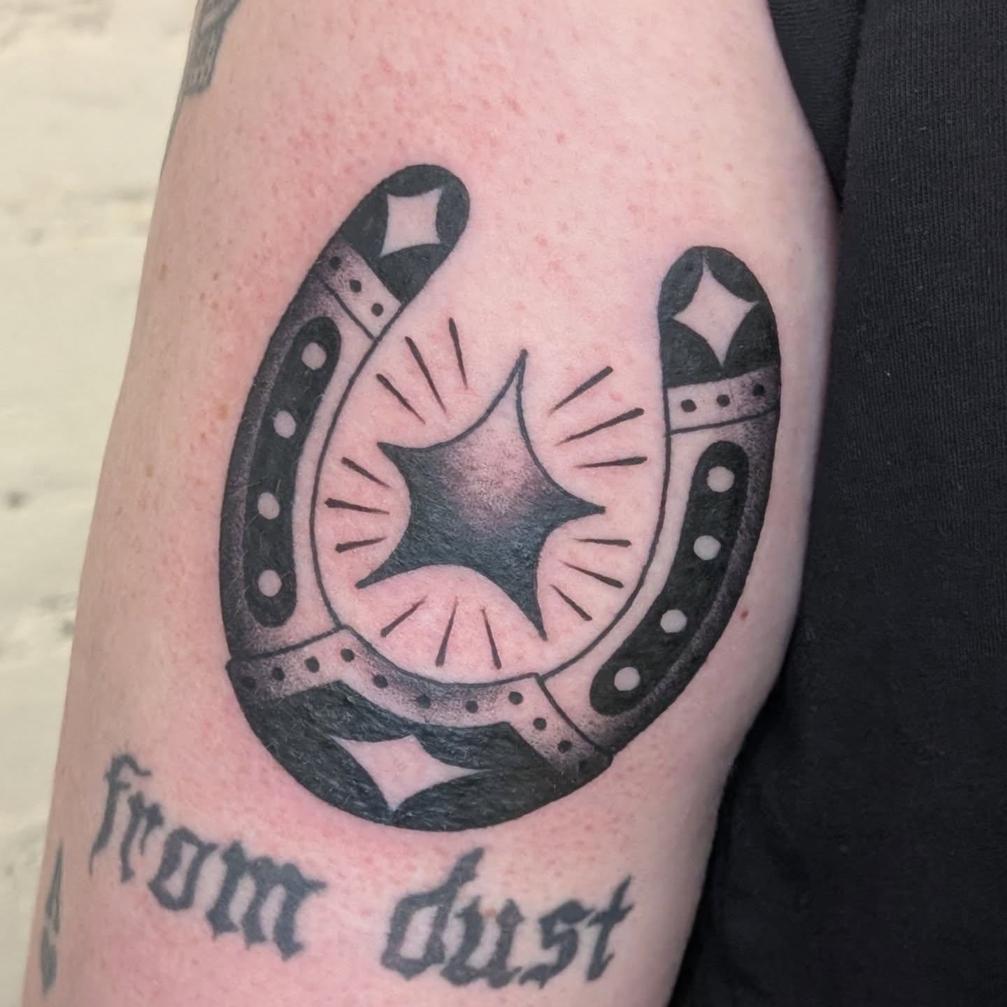 Horseshoe and star black and grey tattoo on the forearm by π²π°πket