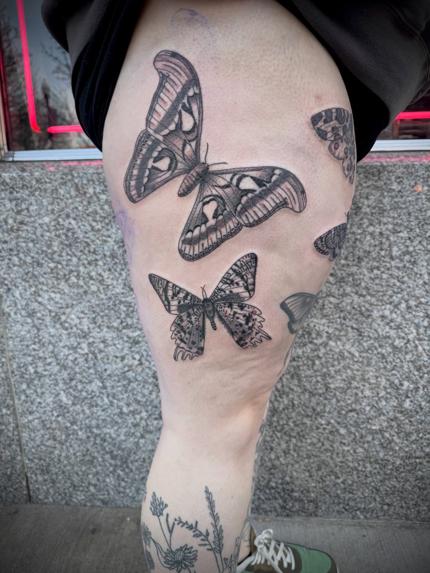 Butterflies black and grey tattoo on the thigh by Kylie Allen
