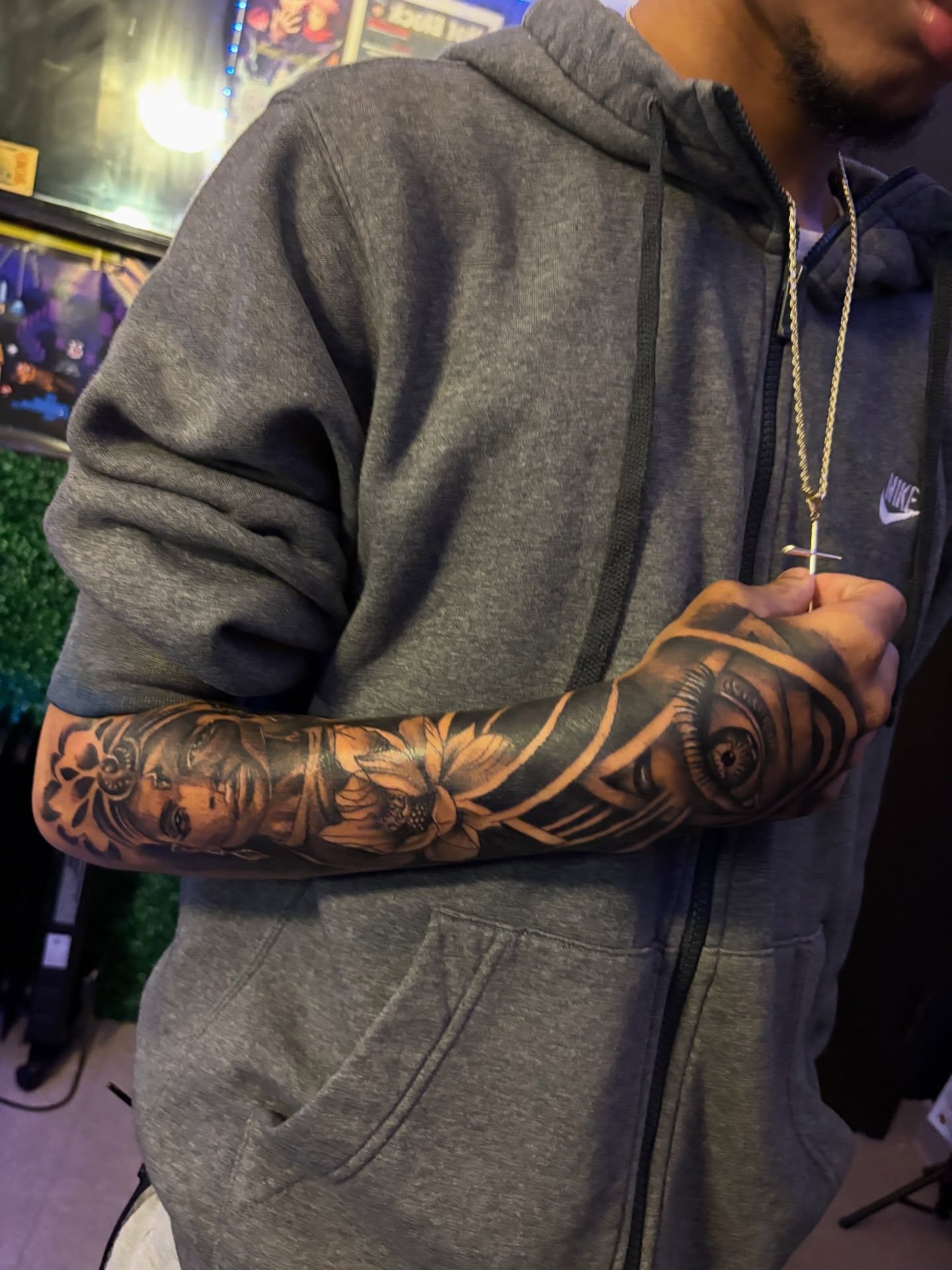 Floral and face realism tattoo on the forearm by Bri Tatted That