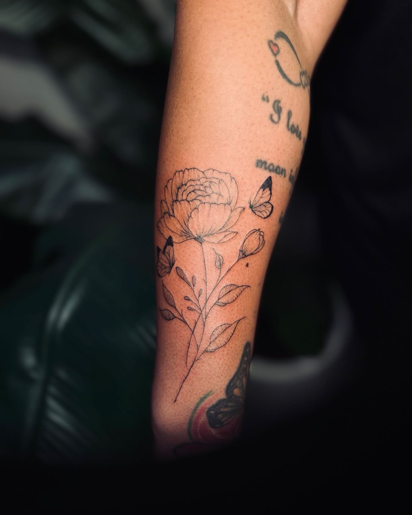 Peony flower fine line tattoo on the forearm by Ashley Pilgreen