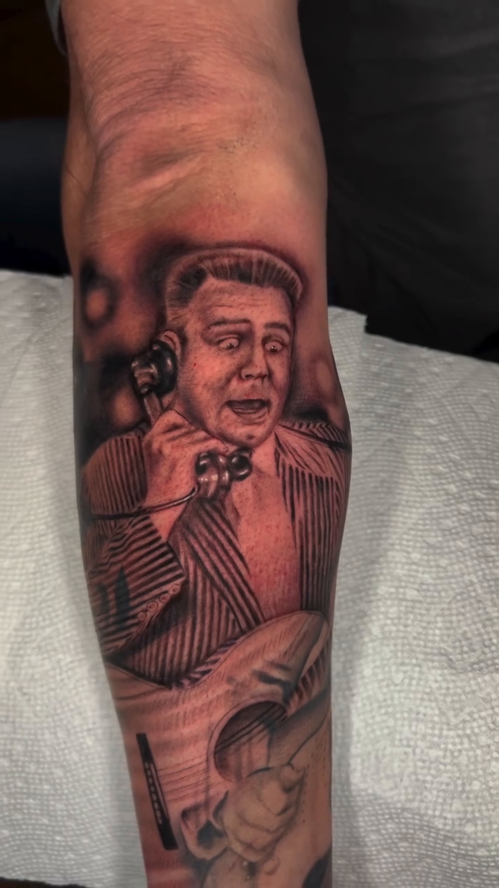 Man on phone realism tattoo by High Vibrations