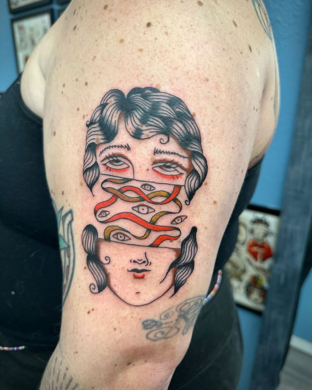 Woman's face with eyes American traditional tattoo on the forearm by rory