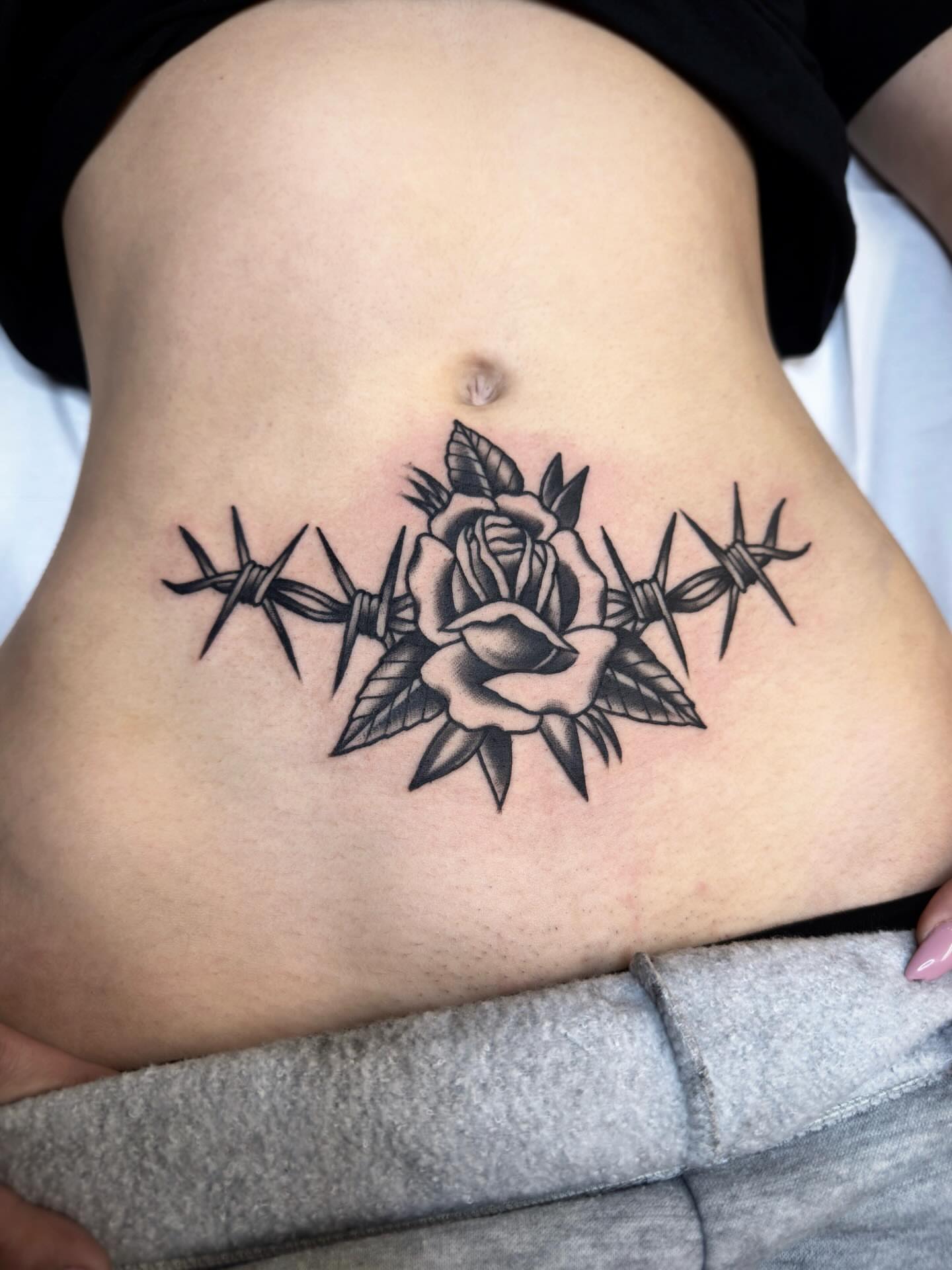 Barbed wire and rose American traditional tattoo on the ribs by Trav, Bayville, New Jersey
