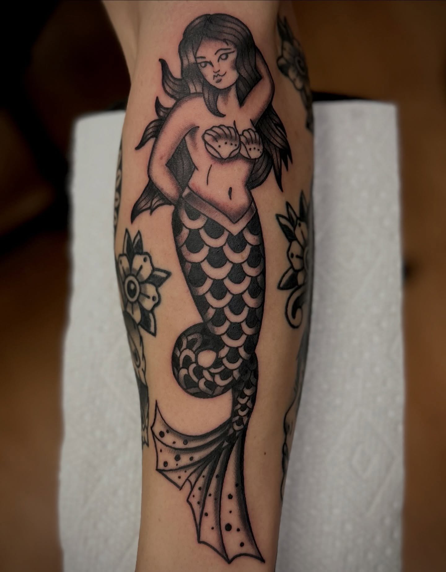 Mermaid American traditional tattoo on the forearm by Josh Robinson
