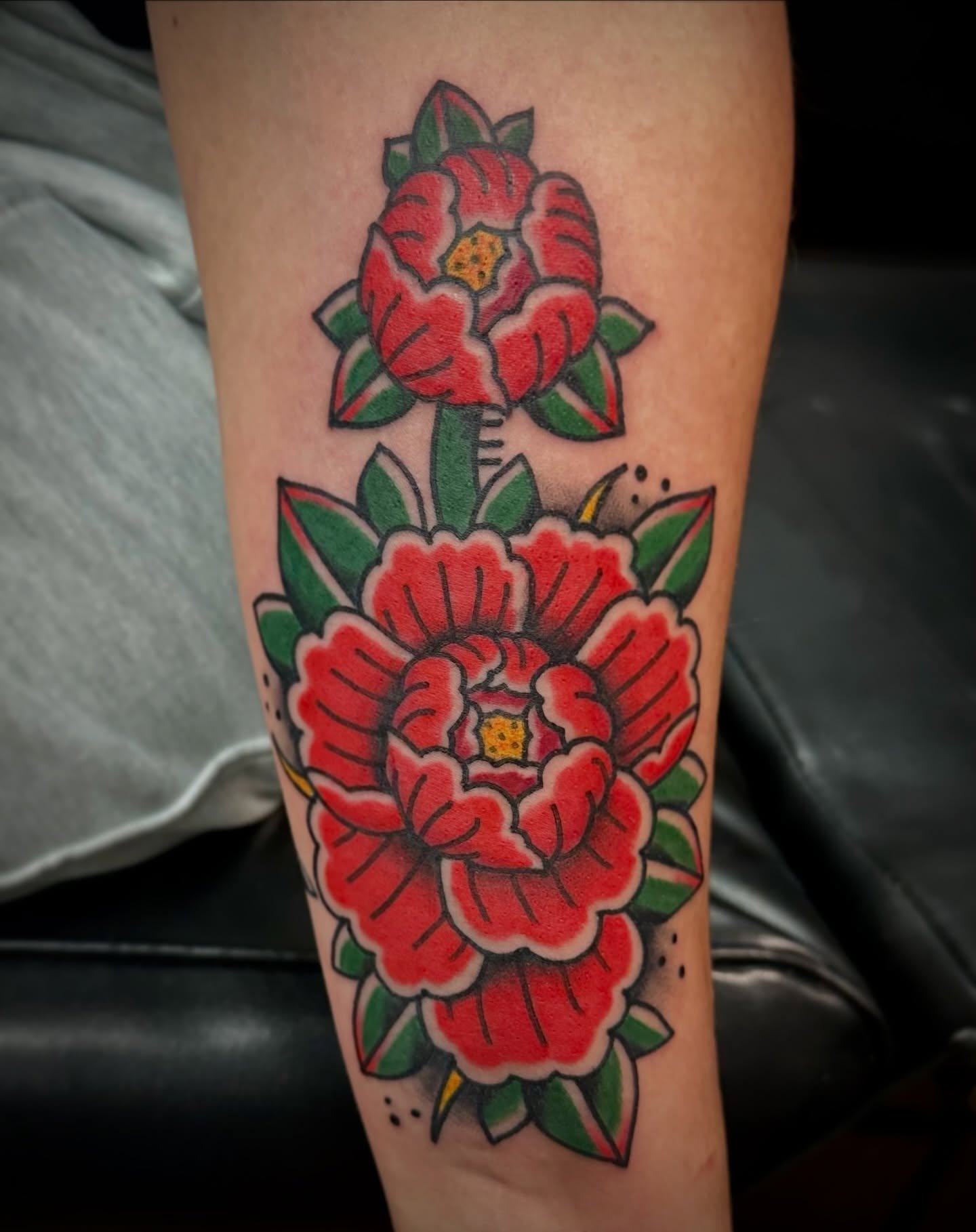 Peony flowers American traditional tattoo on the forearm by Josh Robinson