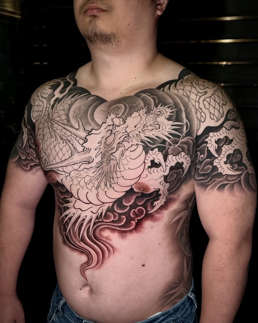 Dragon and clouds Japanese tattoo on the chest by Scienz 九卦刺青