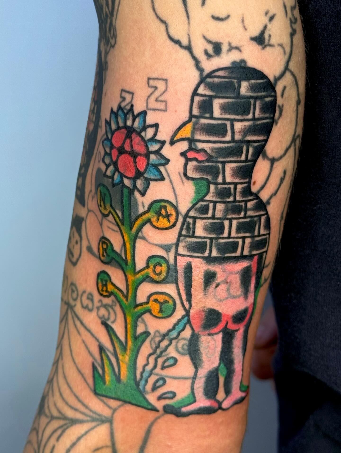 Child with brick wall American traditional tattoo on the forearm by JAX