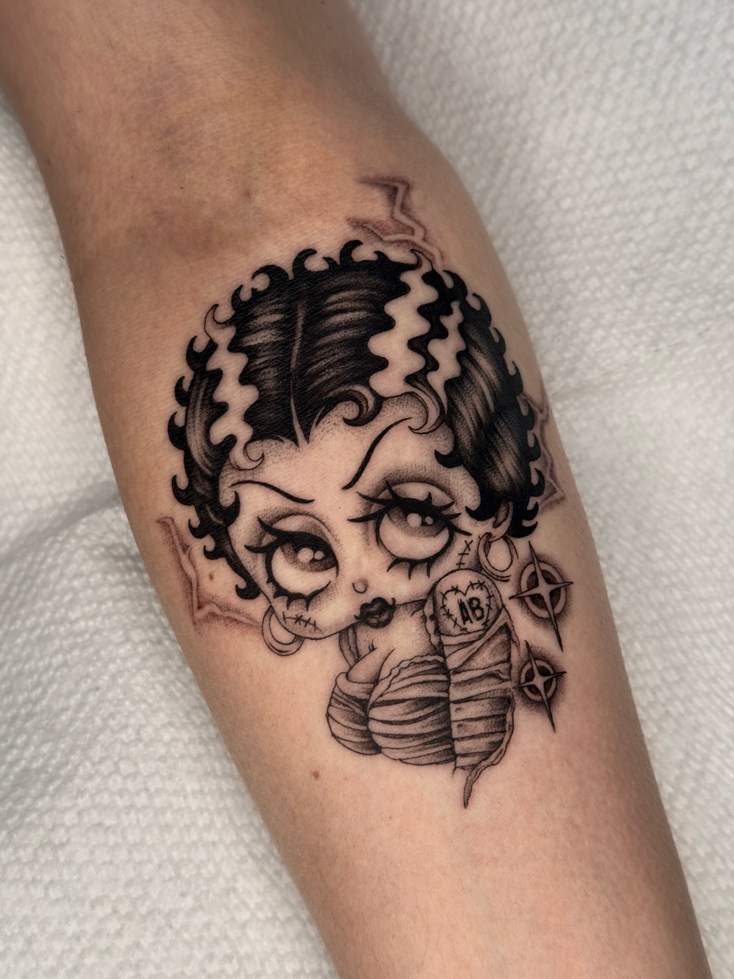Doll realism tattoo on the forearm by ella