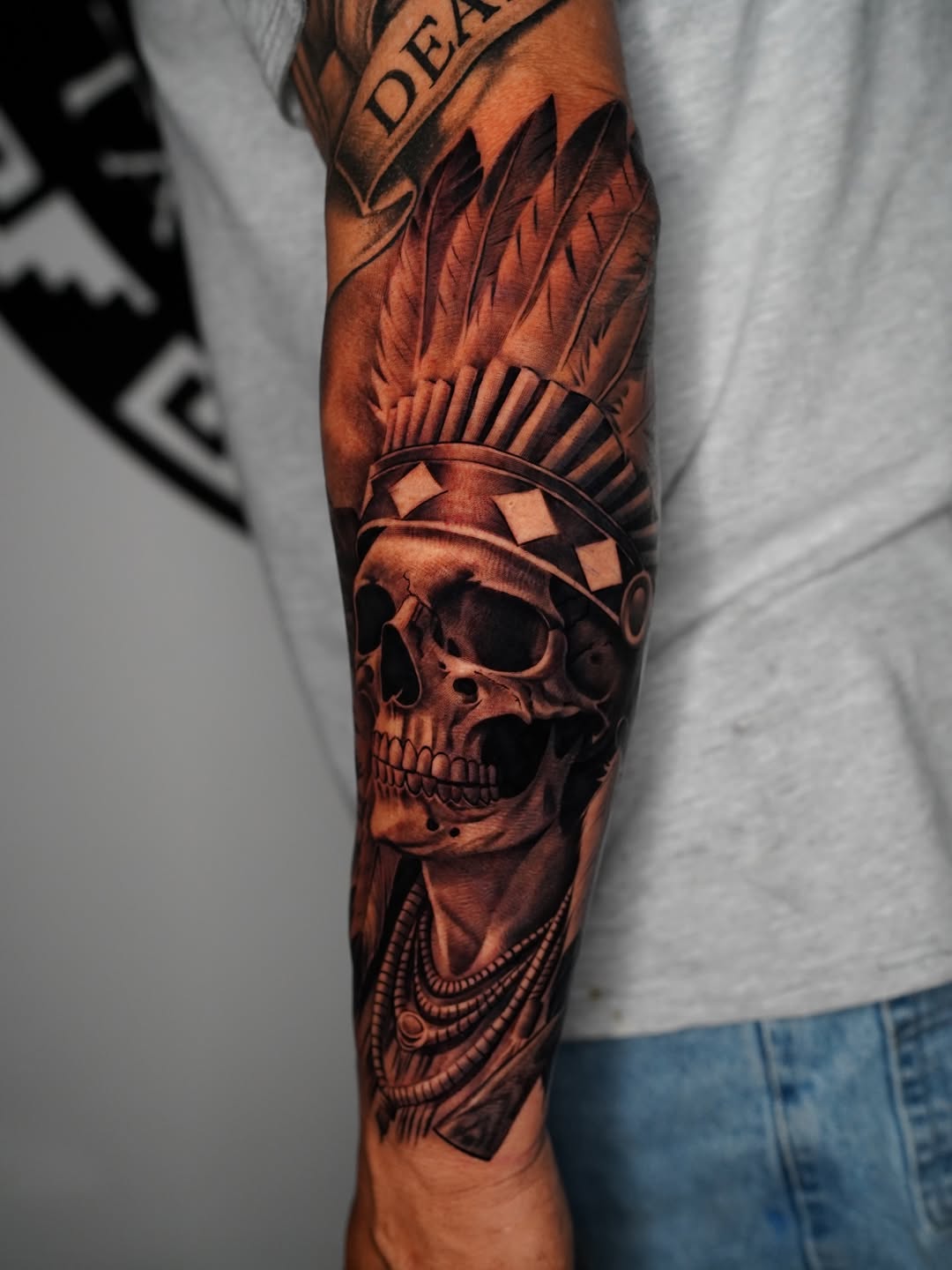 Skull with headdress and jewelry realism tattoo on the forearm by Salvador Saenz Jr, Dallas, Texas
