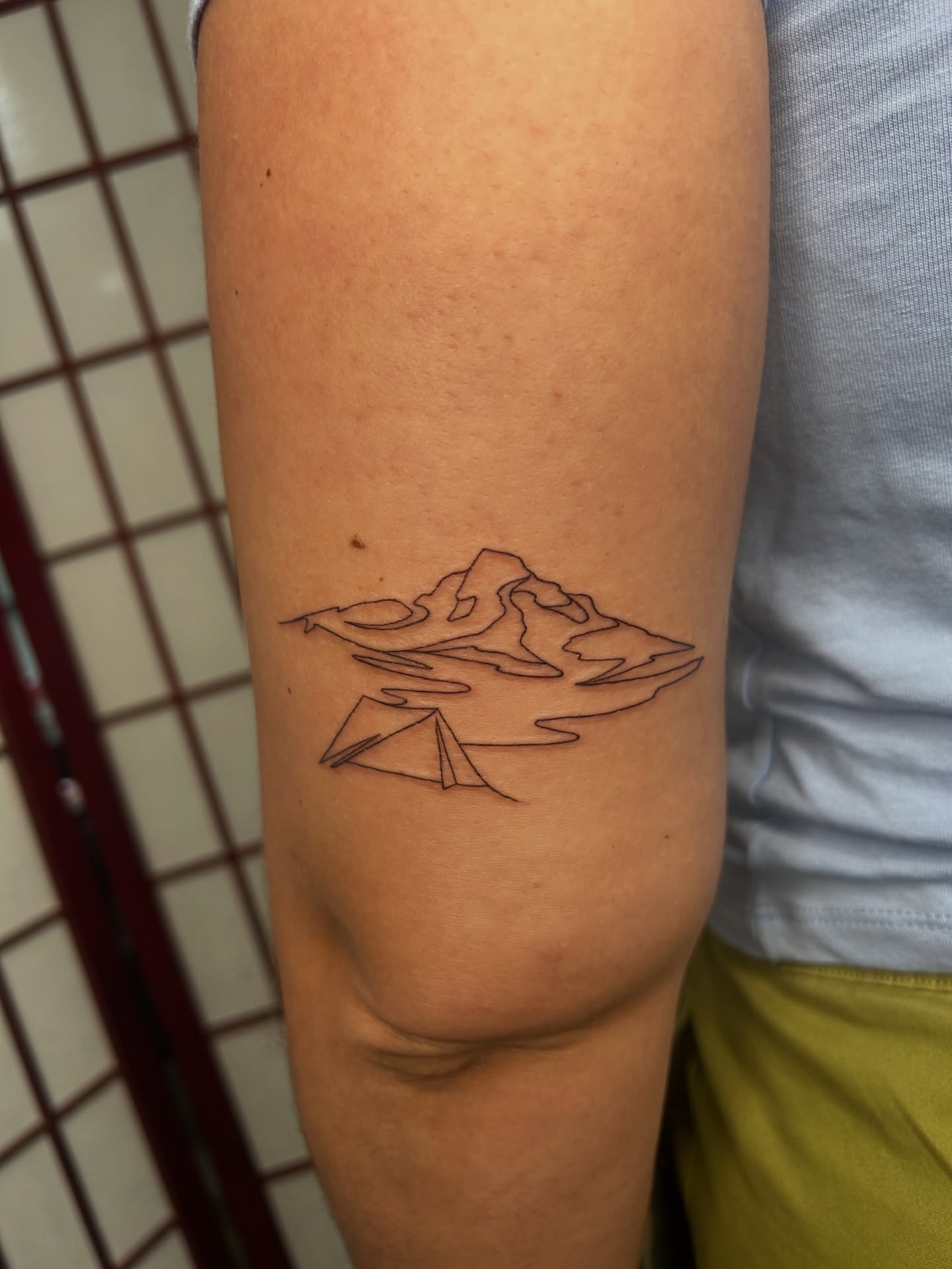 Mountain landscape geometric tattoo on the forearm by Mike Ramos