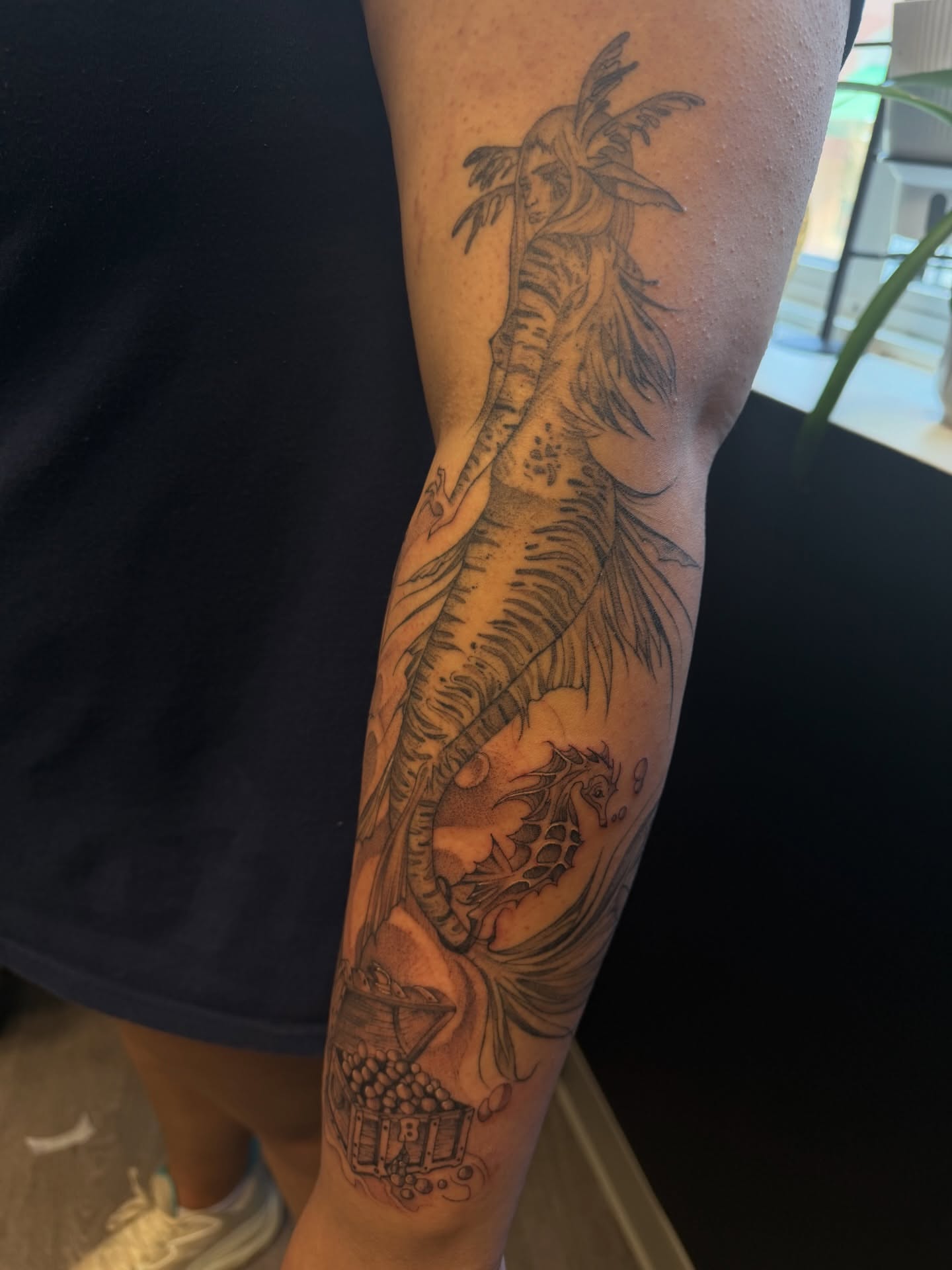 Mermaid and seahorse realism tattoo on the forearm by ashlyn rene